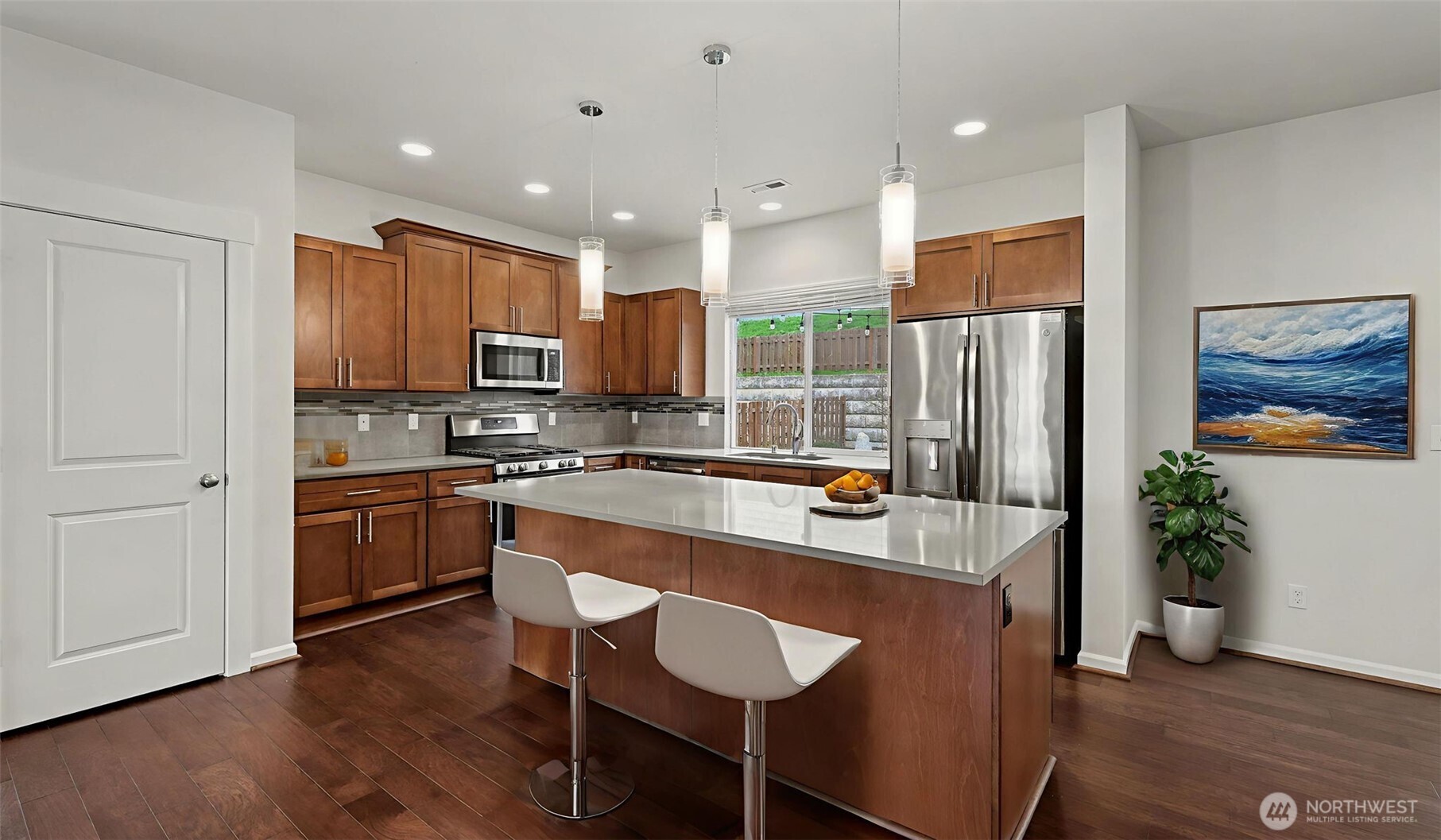 Open gourmet quartz kitchen.