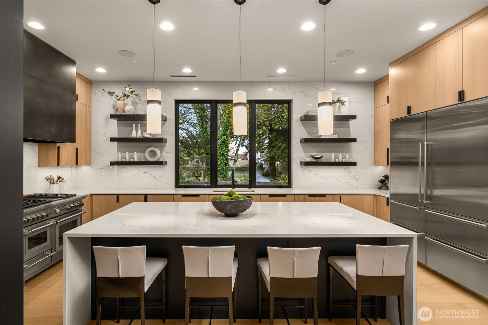 Slab quartz extending to the ceiling and floating shelves.