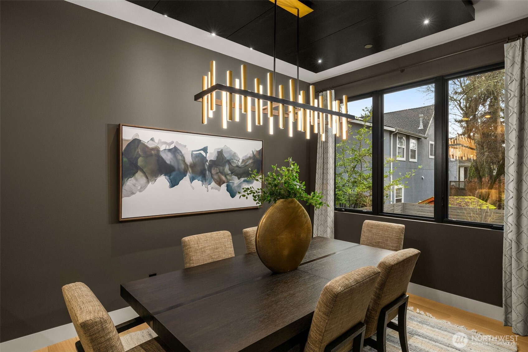 Warm and intimate dining room with Walnut wood ceiling paneling.