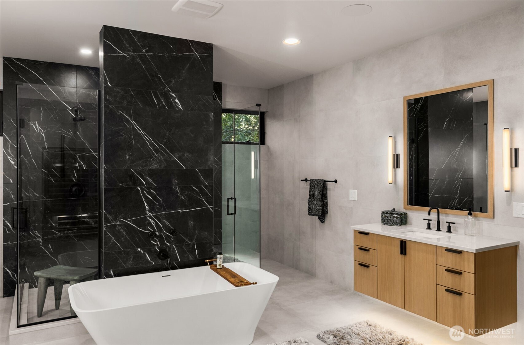Tiled from floor to ceiling. Heated floors. Dual floating vanities. Stand alone sculpture stone, freestanding tub. Slab-built standing shower with dual showerheads and dual entry.