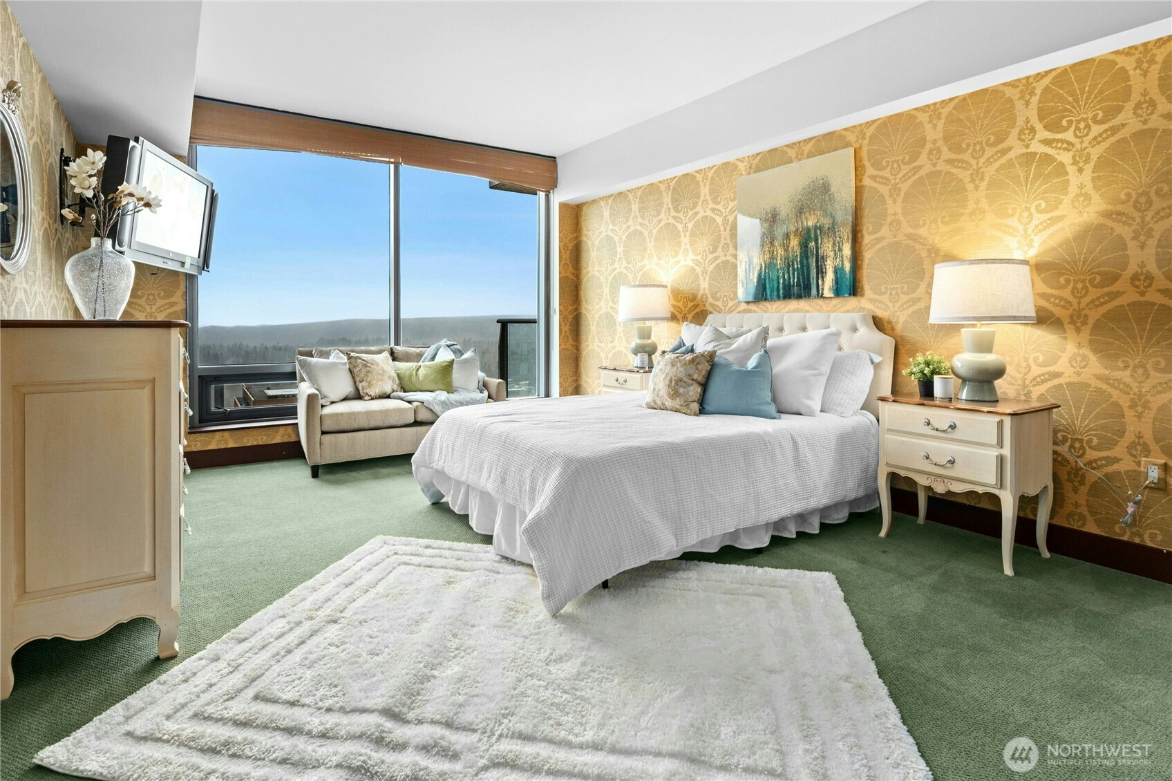 Large primary suite with custom wallpaper, large bathroom and walk in closet.