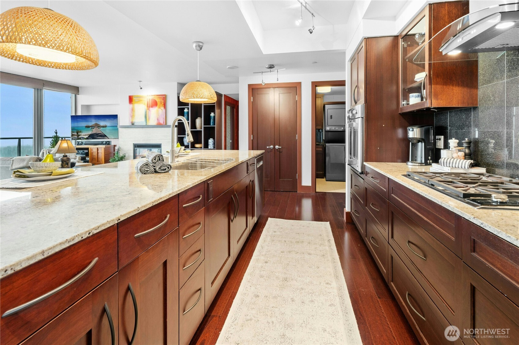 Large island provides plenty of seating, great for entertaining. The kitchen, complete with gas range is fully equipt for a chef! A great room concept allows everyone to enjoy the view!