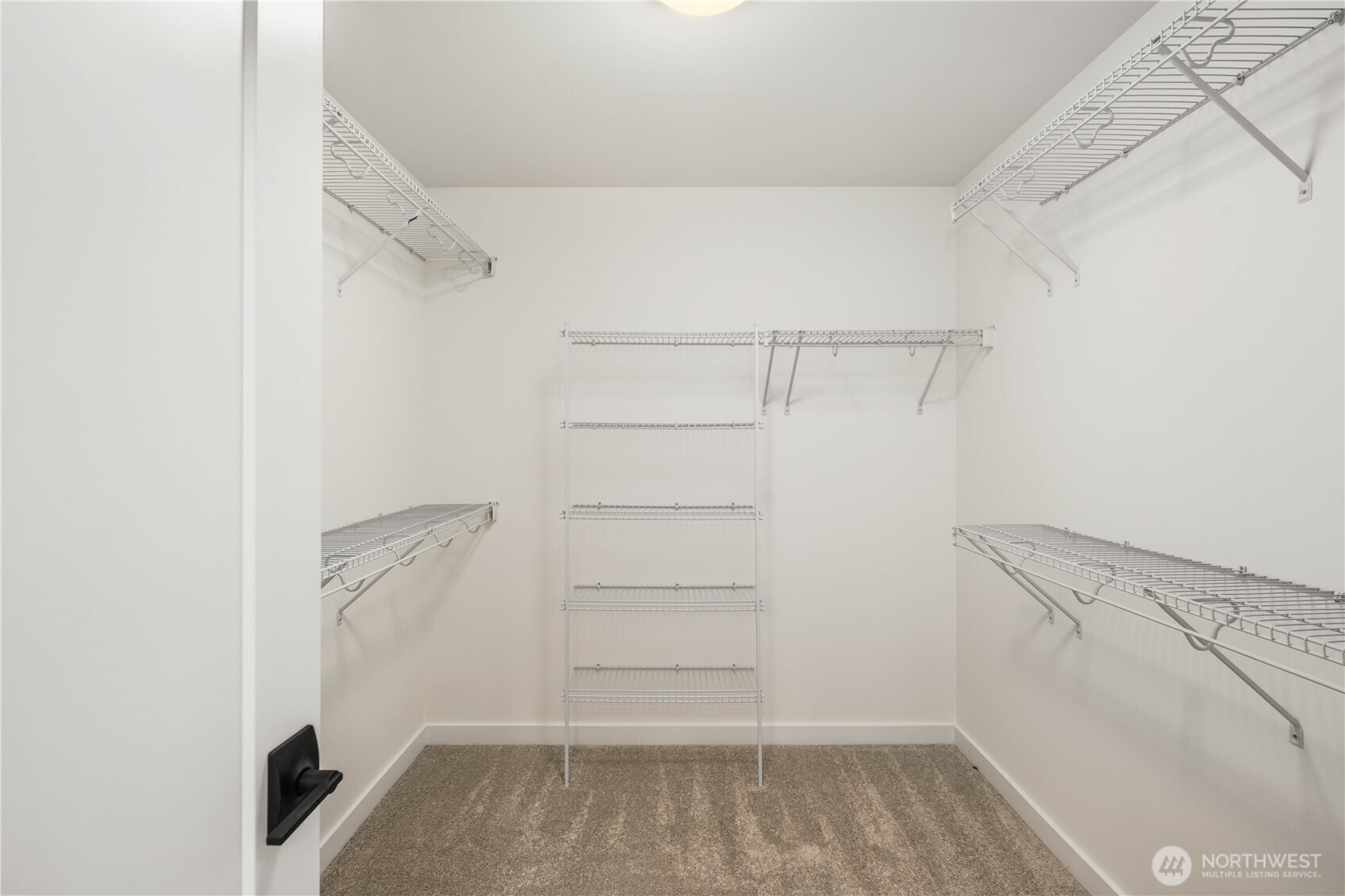 The expansive walk-in closet offers exceptional storage with multiple hanging zones and shelving throughout. Its generous layout supports easy organization and a streamlined morning routine directly off the ensuite bath.    These photos are from lot 3 at Gooden Hollow, the actual home for sale. However, other homes may vary, so all photos, renderings, site maps, and floorplans are for visualization purposes only. Plans, colors, building orientation, finishes, home outlook, and other details can and WILL vary.