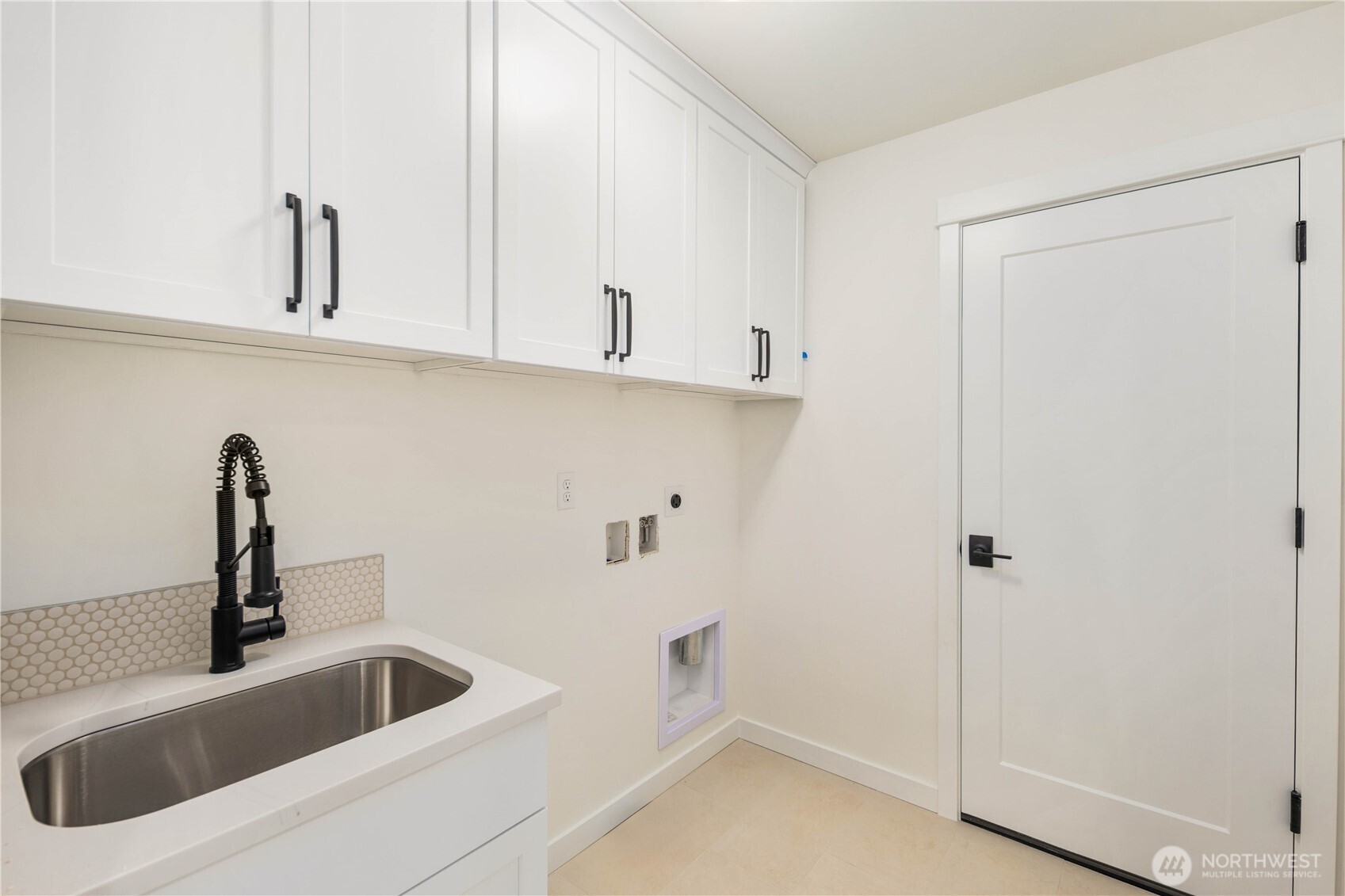 The upper-level laundry room includes generous cabinetry, a deep utility sink, and thoughtful storage to keep daily tasks running smoothly. Its placement near the bedrooms adds convenience and efficiency.    These photos are from lot 3 at Gooden Hollow, the actual home for sale. However, other homes may vary, so all photos, renderings, site maps, and floorplans are for visualization purposes only. Plans, colors, building orientation, finishes, home outlook, and other details can and WILL vary.