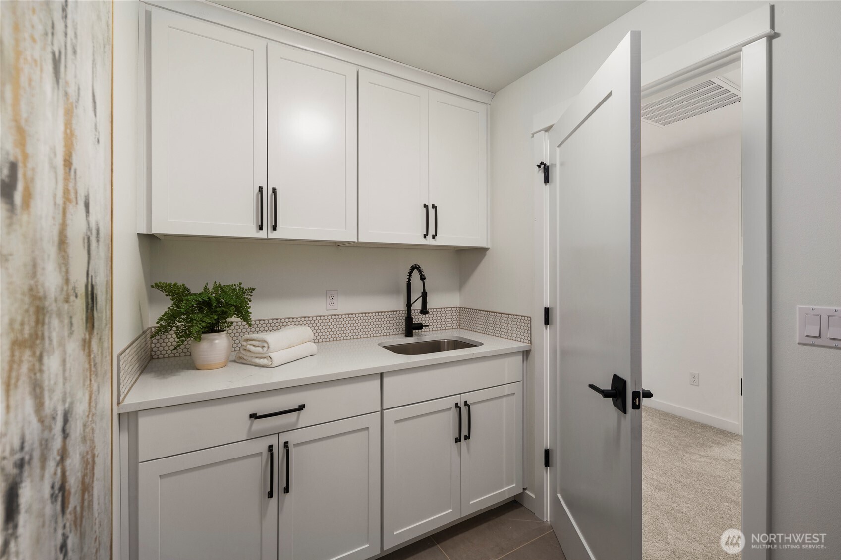 Laundry Room: Upper-level laundry includes cabinetry, sink, and counter workspace for added functionality. Washer and dryer not included, allowing buyers to select appliances that fit their needs.    Photos are from the model home at Foxmoore and for visualization purposes only. Plans, colors, building orientation, finishes, home outlook, and other details can and WILL vary.