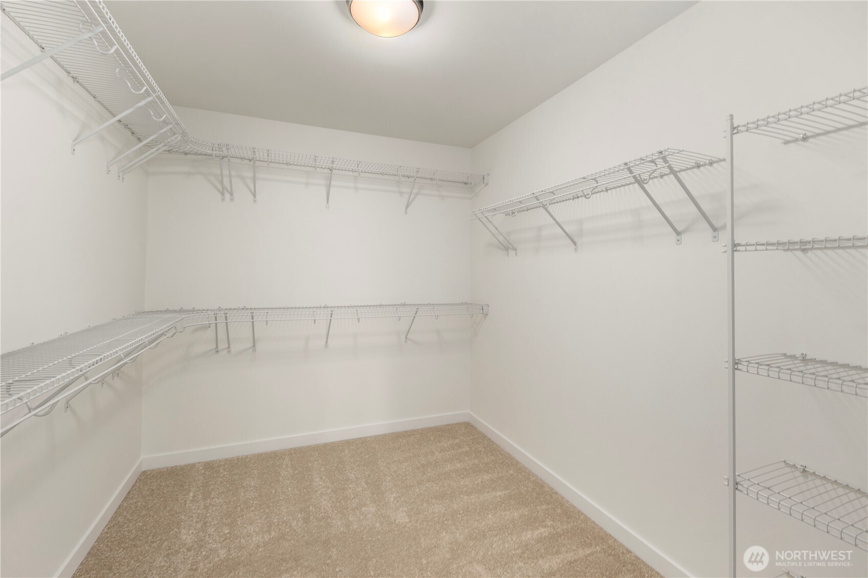 Primary Walk-In Closet: Oversized walk-in closet includes extensive shelving and hanging space. Designed for organization, it keeps everything within easy reach while maximizing storage.    Photos are from THIS model home at Foxmoore but are for visualization purposes only.