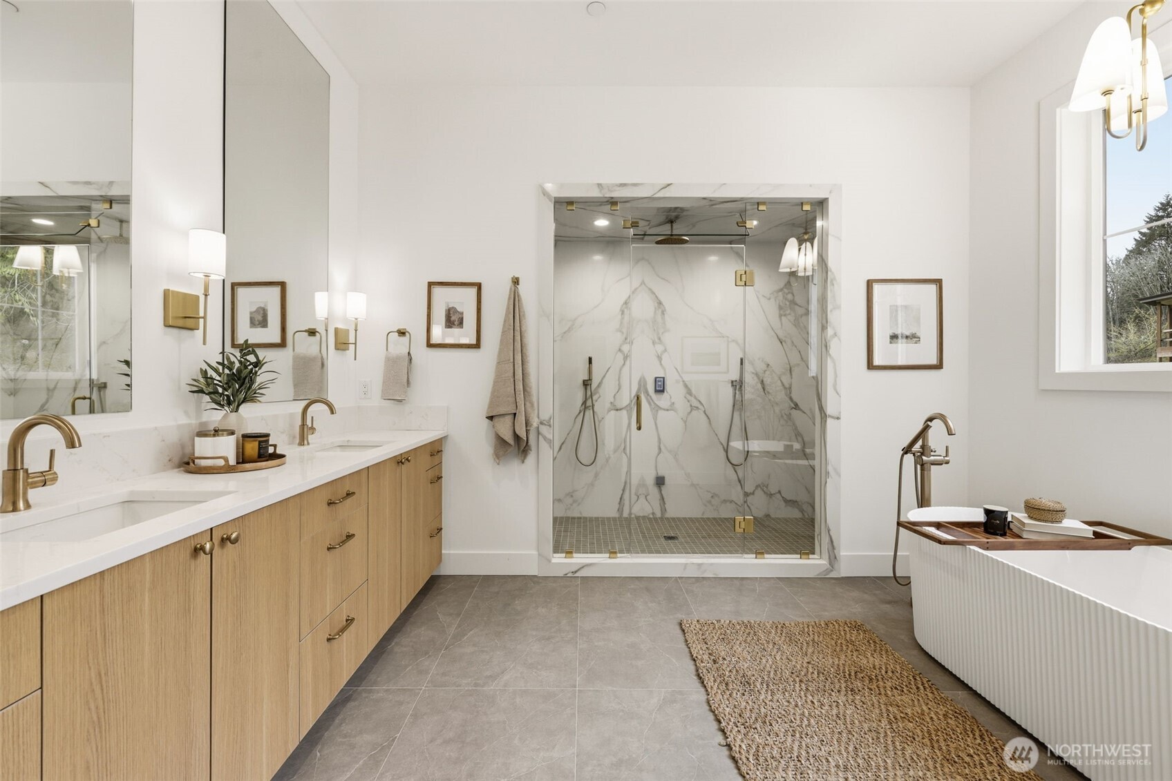 Upstairs primary retreat featuring a double–shower head steam shower, stunning fluted soaking tub, and two closets.