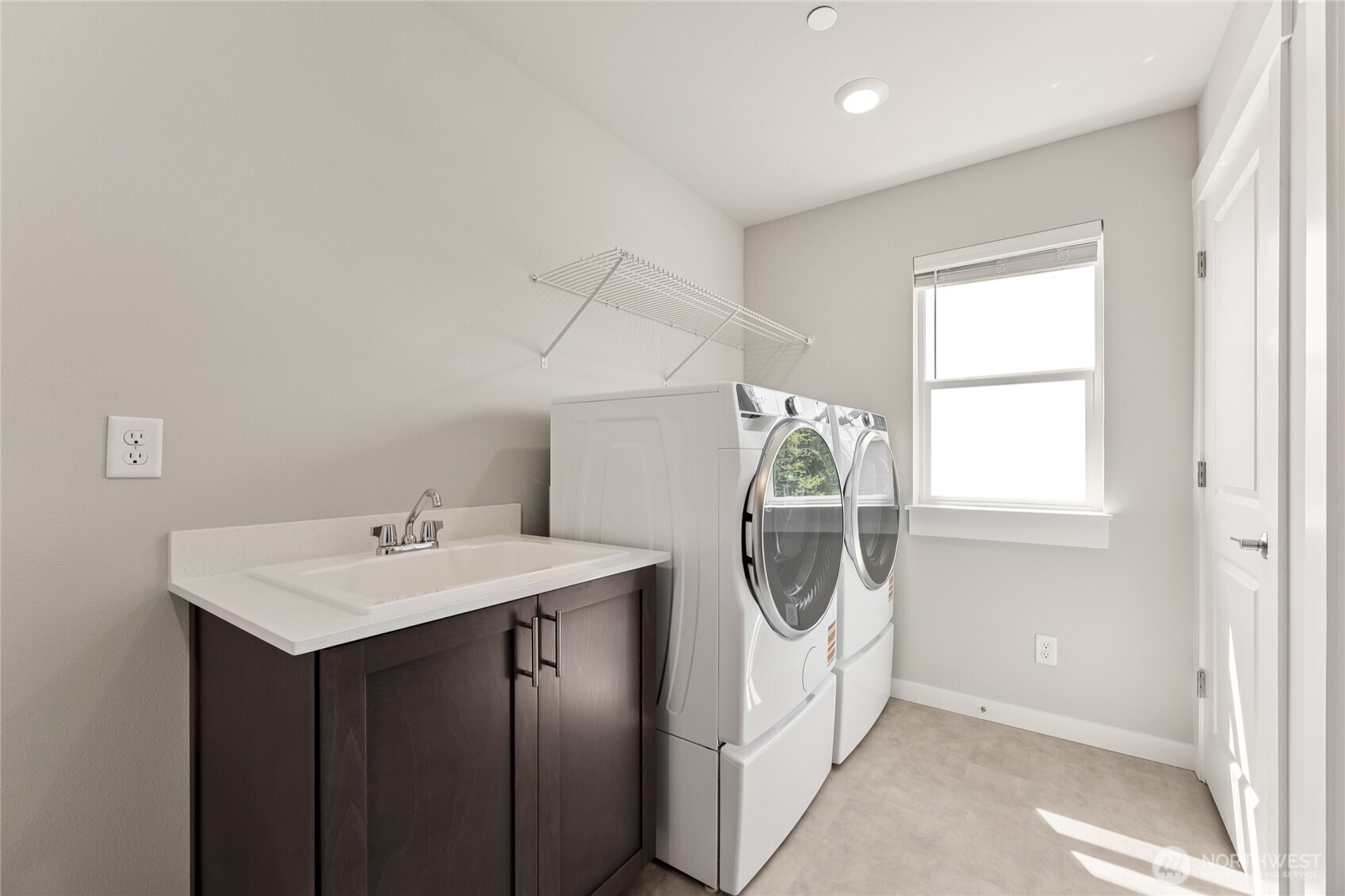 Laundry room with utility sink, washer & dryer are an option.