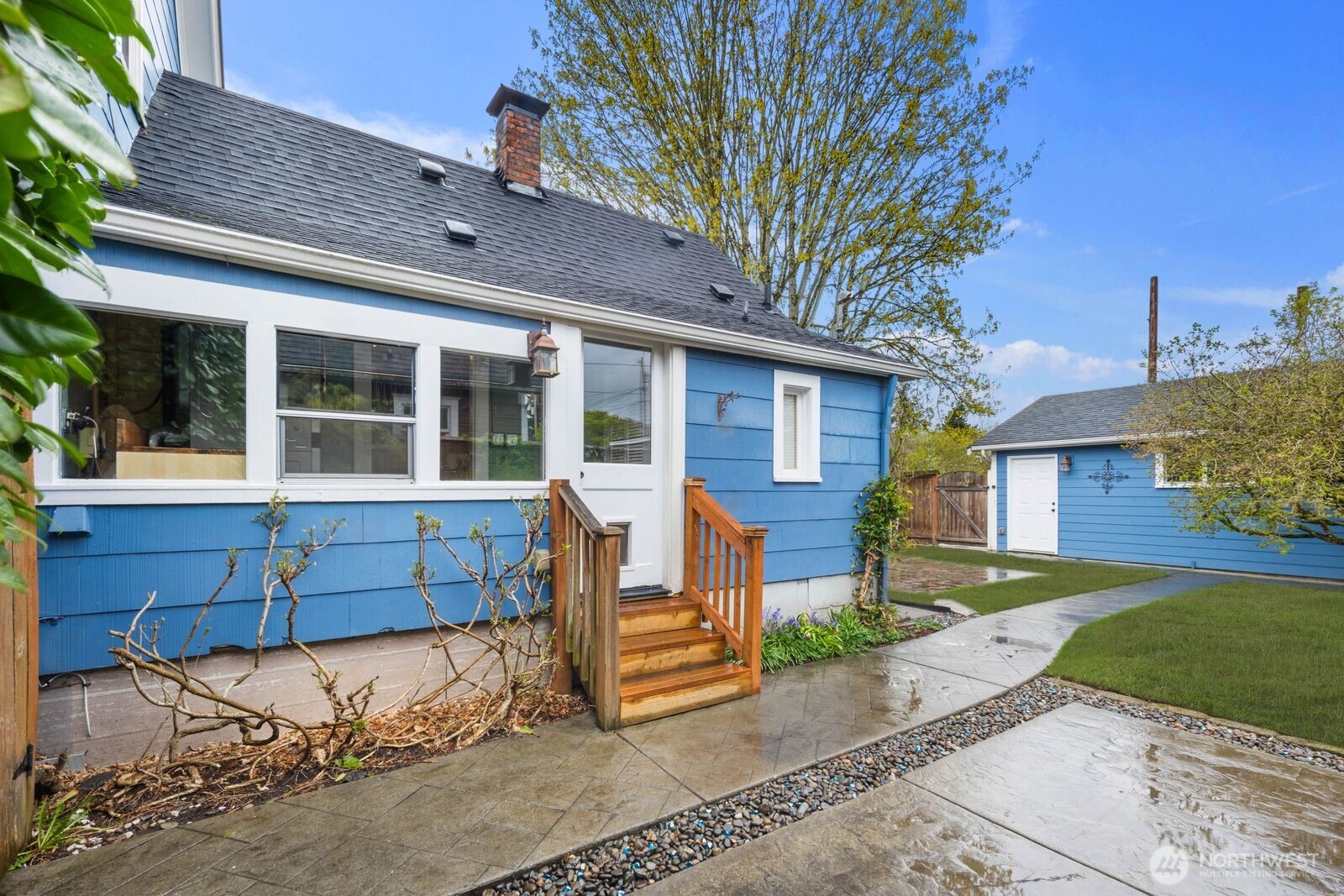 Side door from laundry/mud room to back yard and garage with grass replacement.