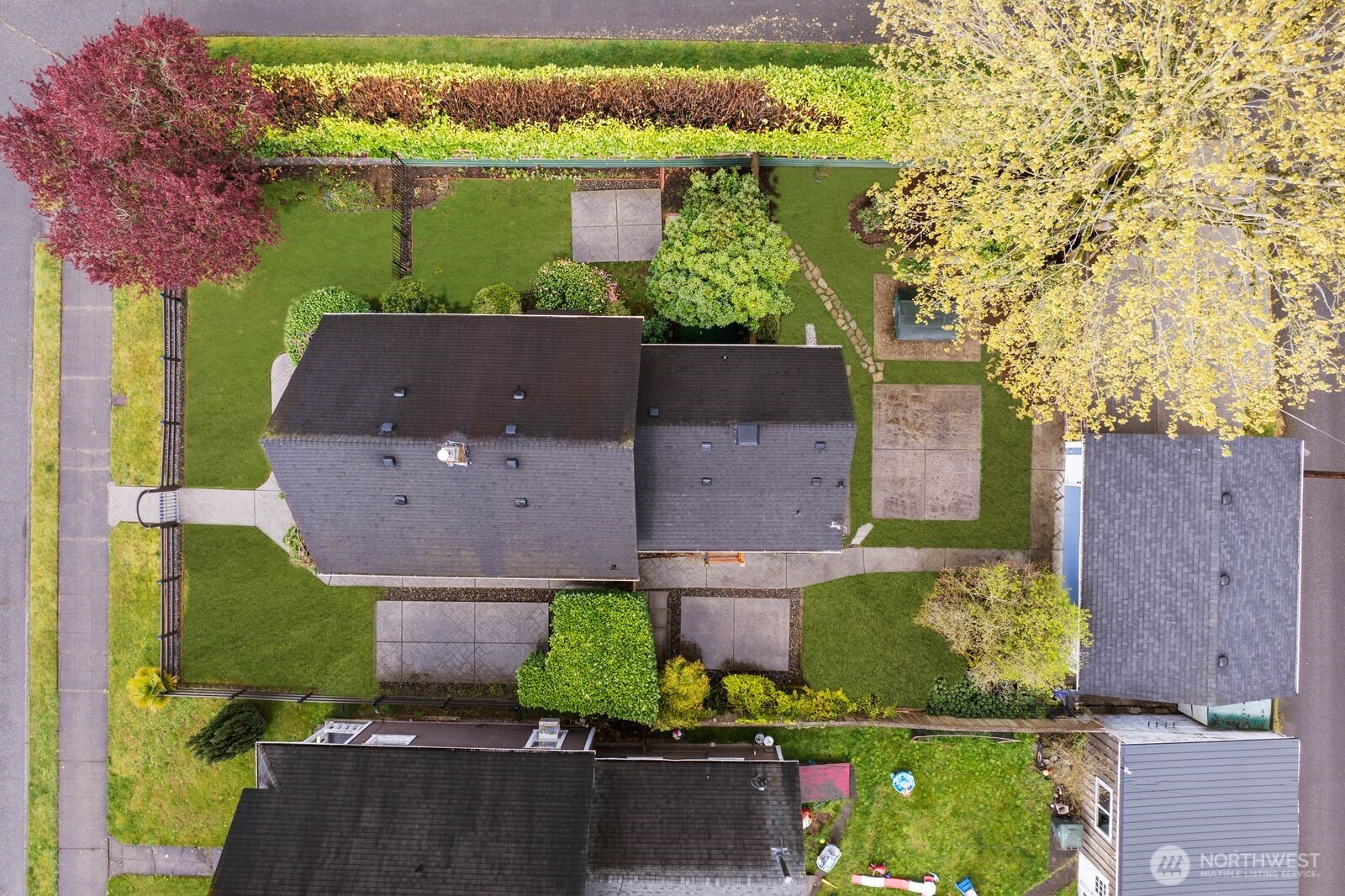 View of corner lot and detached garage off of the alley with grass replacement.