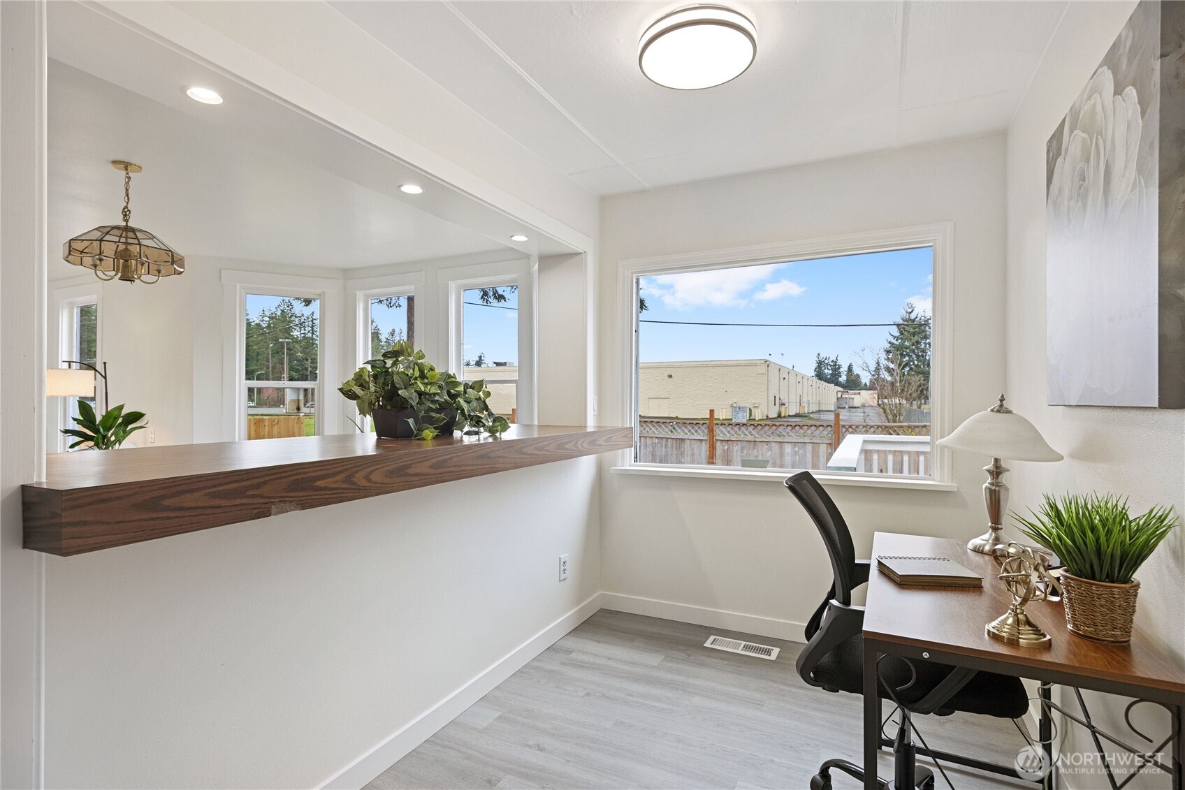 The large open kitchen has abundant cabinet and counter space, new quartz counter tops, new dishwasher and lower cabinets.