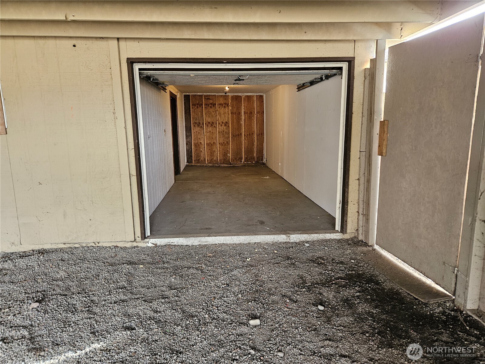 Single car garage in back of carport.