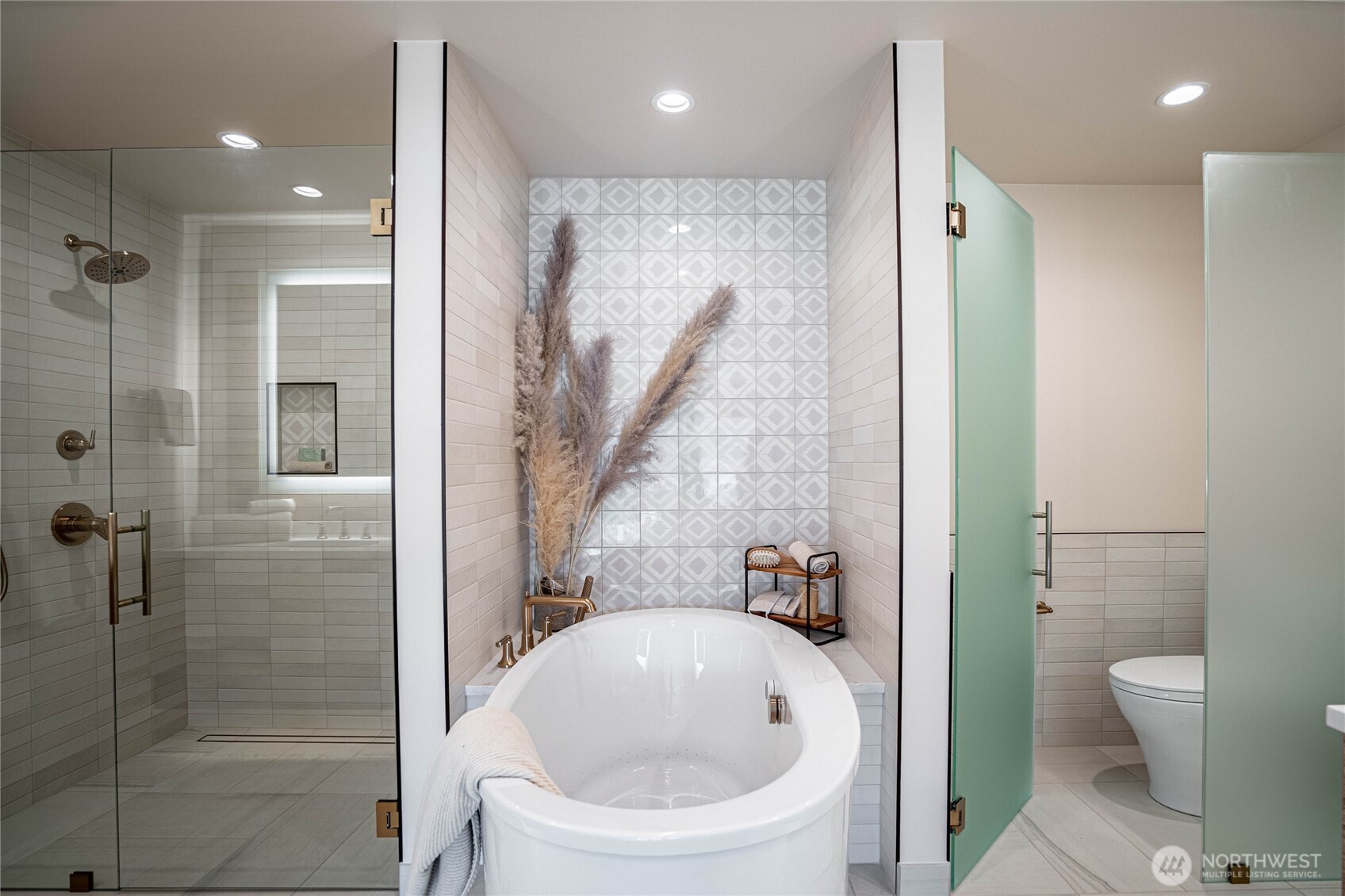 Modern jetted self-cleaning soaking tub is the focal point of the en suite primary bathroom.