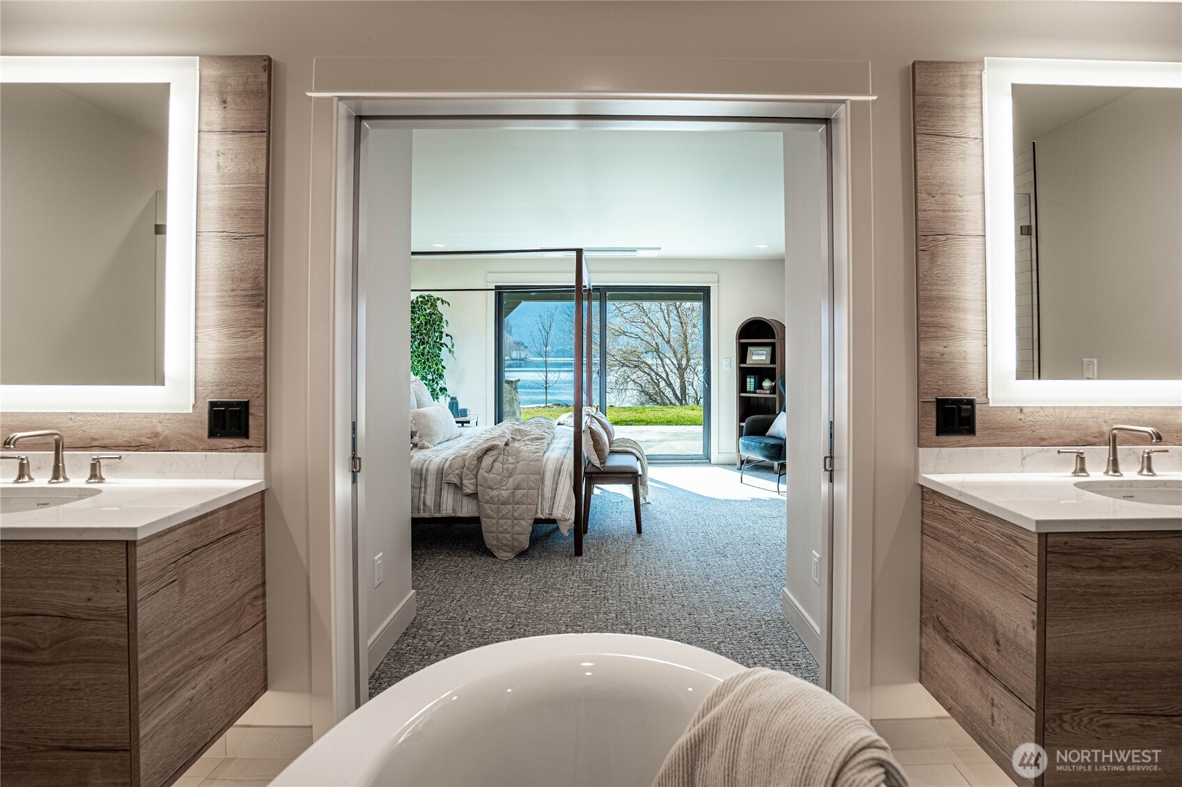 Twin bathroom sinks in the en suite primary bathroom with halo-illuminated mirrors.