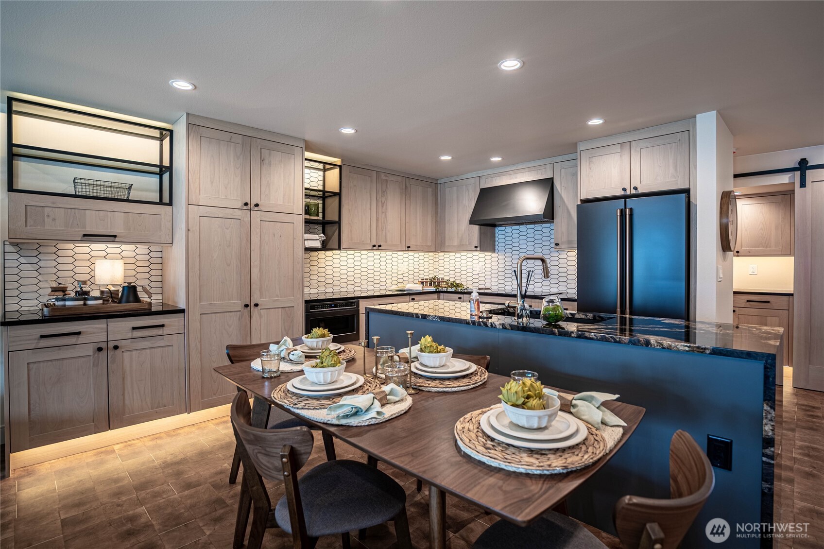 Modern kitchen counters and luxury appliances accented by automatic undercounter and undercabinet lighting. Ample kitchen storage space.