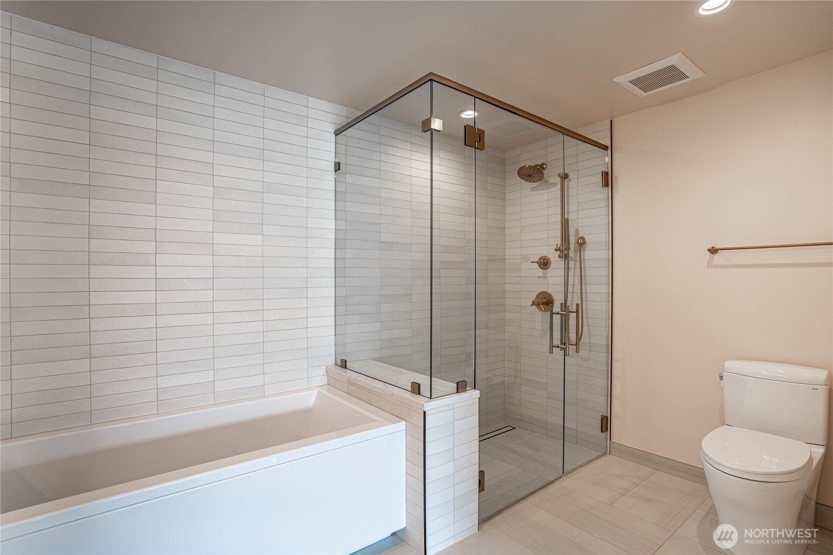Oversized shower with massage fixtures and beautiful tile work.