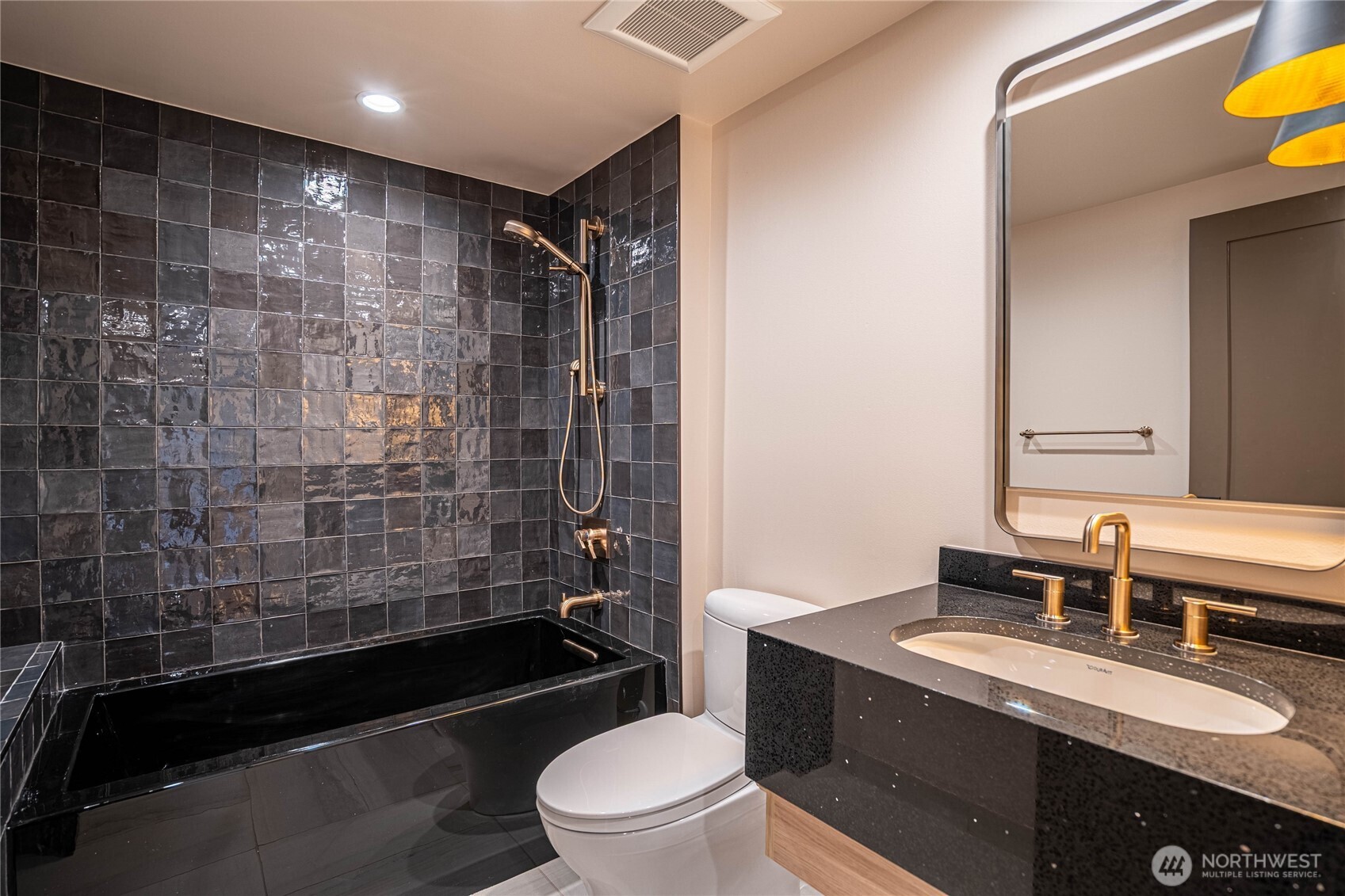 Main floor guest bathroom features a full bathtub and massage jet shower.