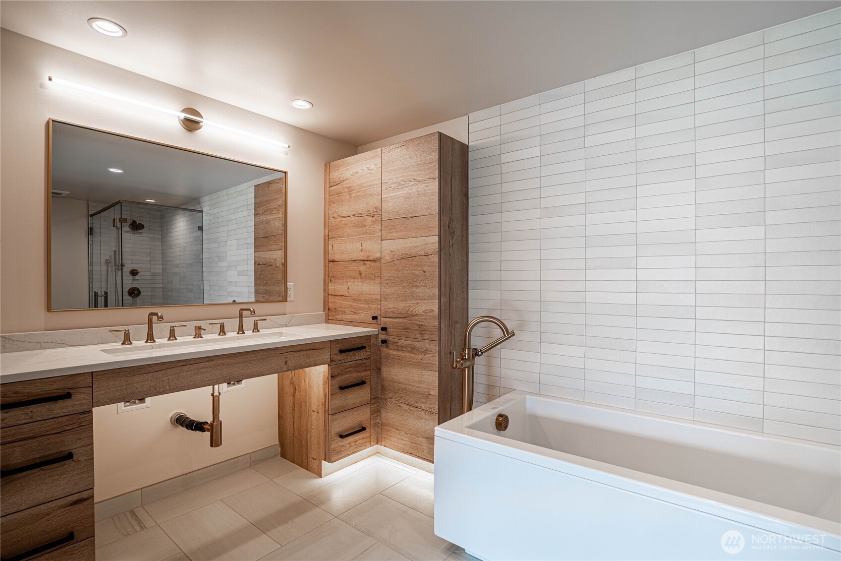 Spacious bathroom counter in the en suite primary bathroom with halo-illuminated mirror.