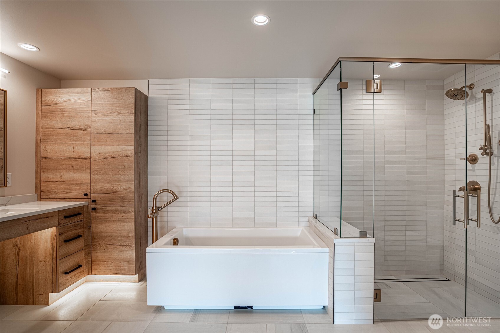 Modern jetted self-cleaning soaking tub is the focal point of the en suite primary bathroom.