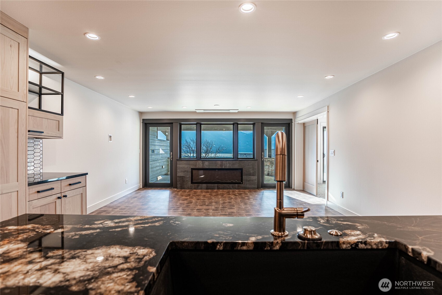 Striking solid slab marble kitchen counters and stylish gold fixtures are highlights in the kitchen with lake views always in sight.