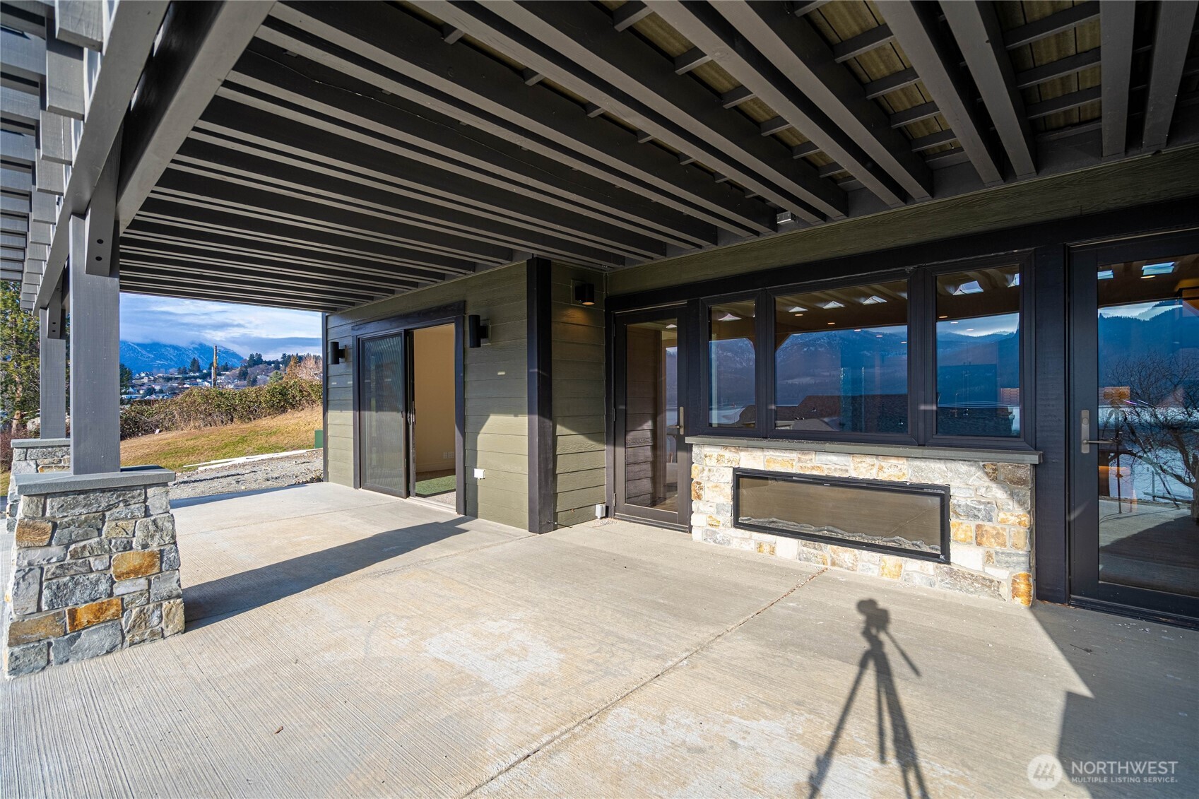 Double-sided fireplace offers year-round relaxation, indoors or out.