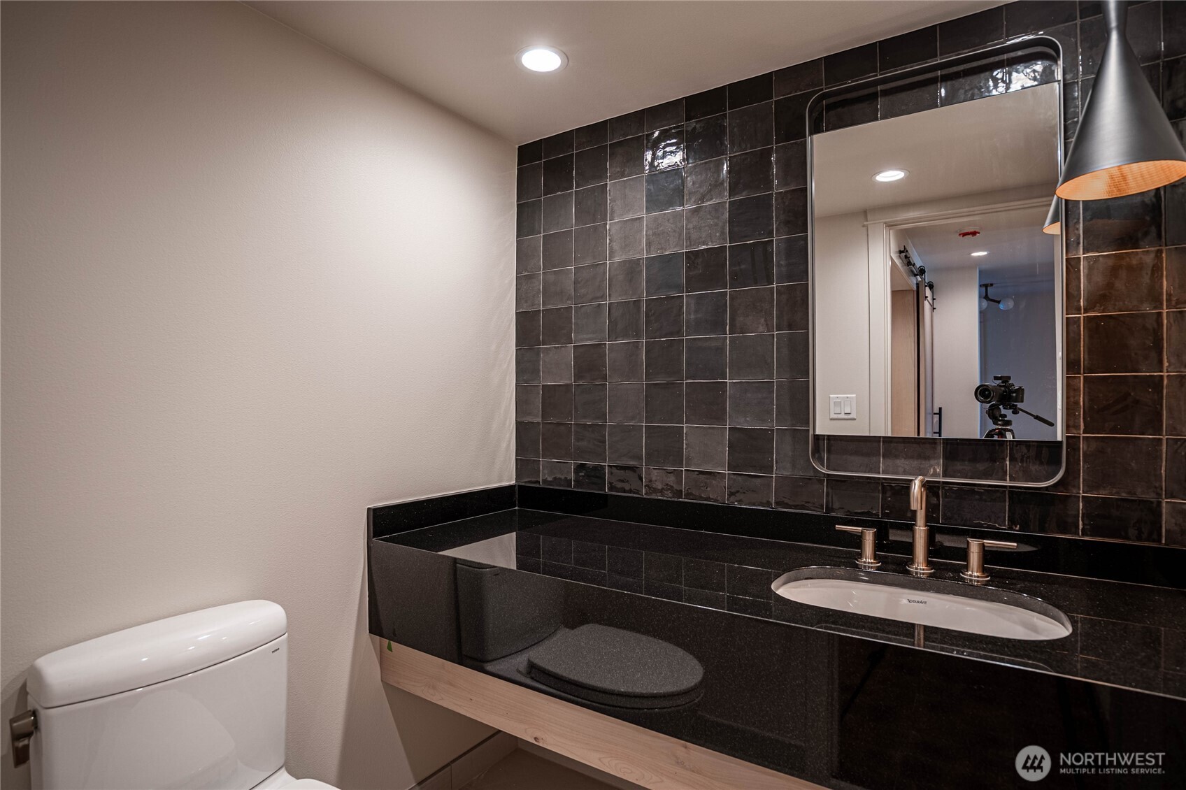 Stylish and modern half-bath in the entry area.