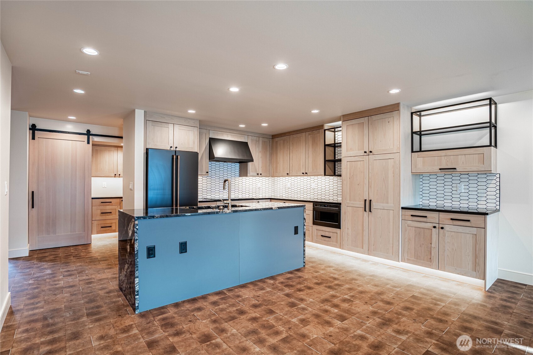 Modern kitchen counters and luxury appliances accented by automatic undercounter and undercabinet lighting. Ample kitchen storage space.