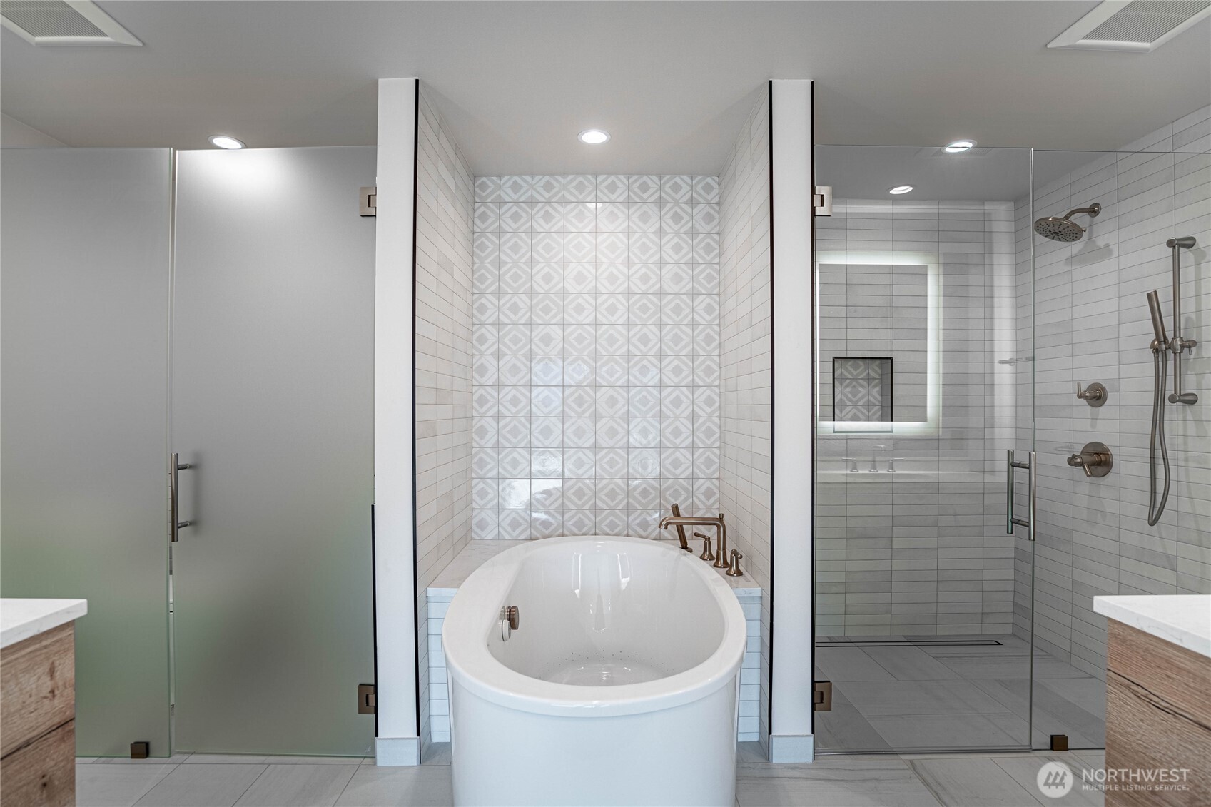Modern jetted self-cleaning soaking tub is the focal point of the en suite primary bathroom.