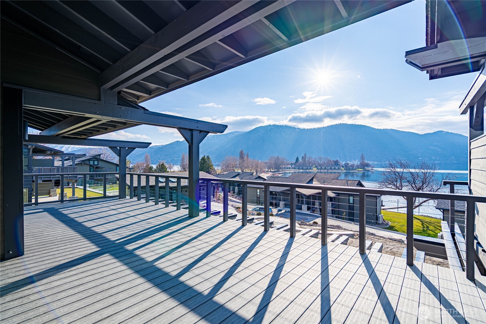Indoor outdoor living with the double-sided fireplace and twin doors opening to the deck.  The living room offers relaxing space all year round.