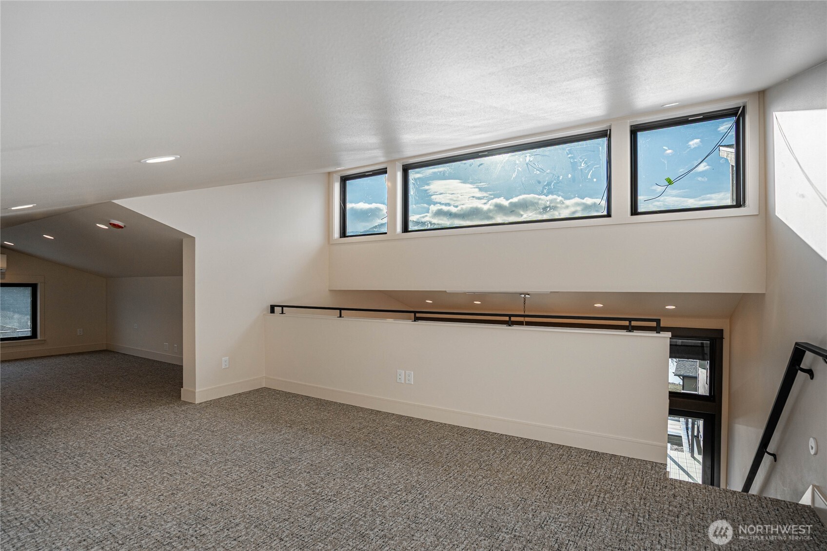 Loft area includes a bonus room and sleeping area with clerestory windows.