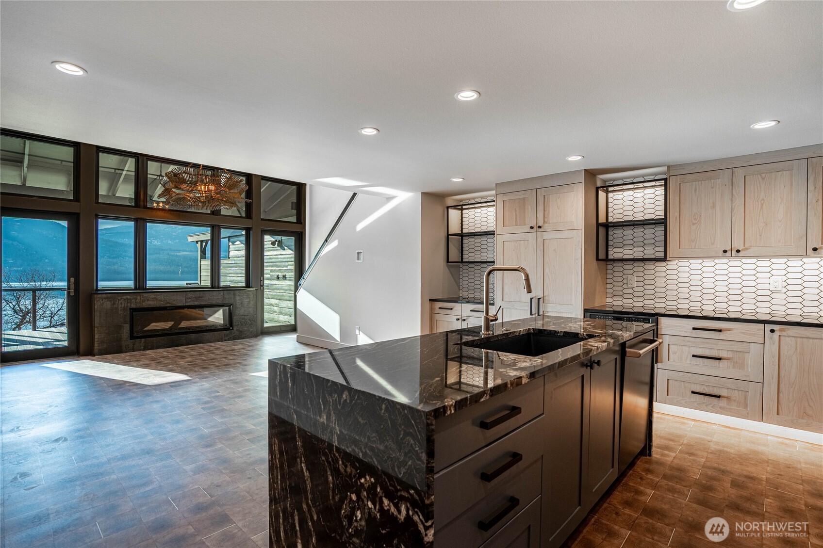 Fully renovated open floor plan with beautiful kitchen counters and luxury appliances. Kitchens opens to the dining area and living room with fireplace and amazing lake views.