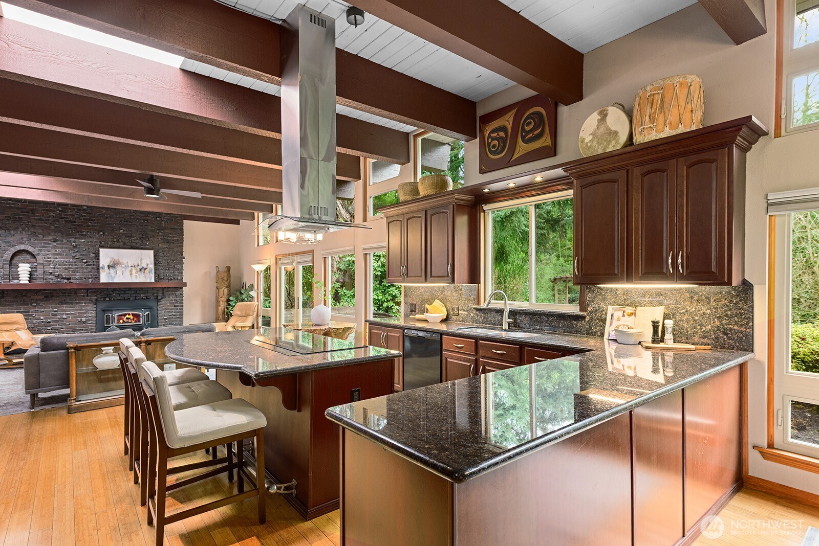 The kitchen features an induction cooktop, eat-in space, and plenty of counter and storage space.