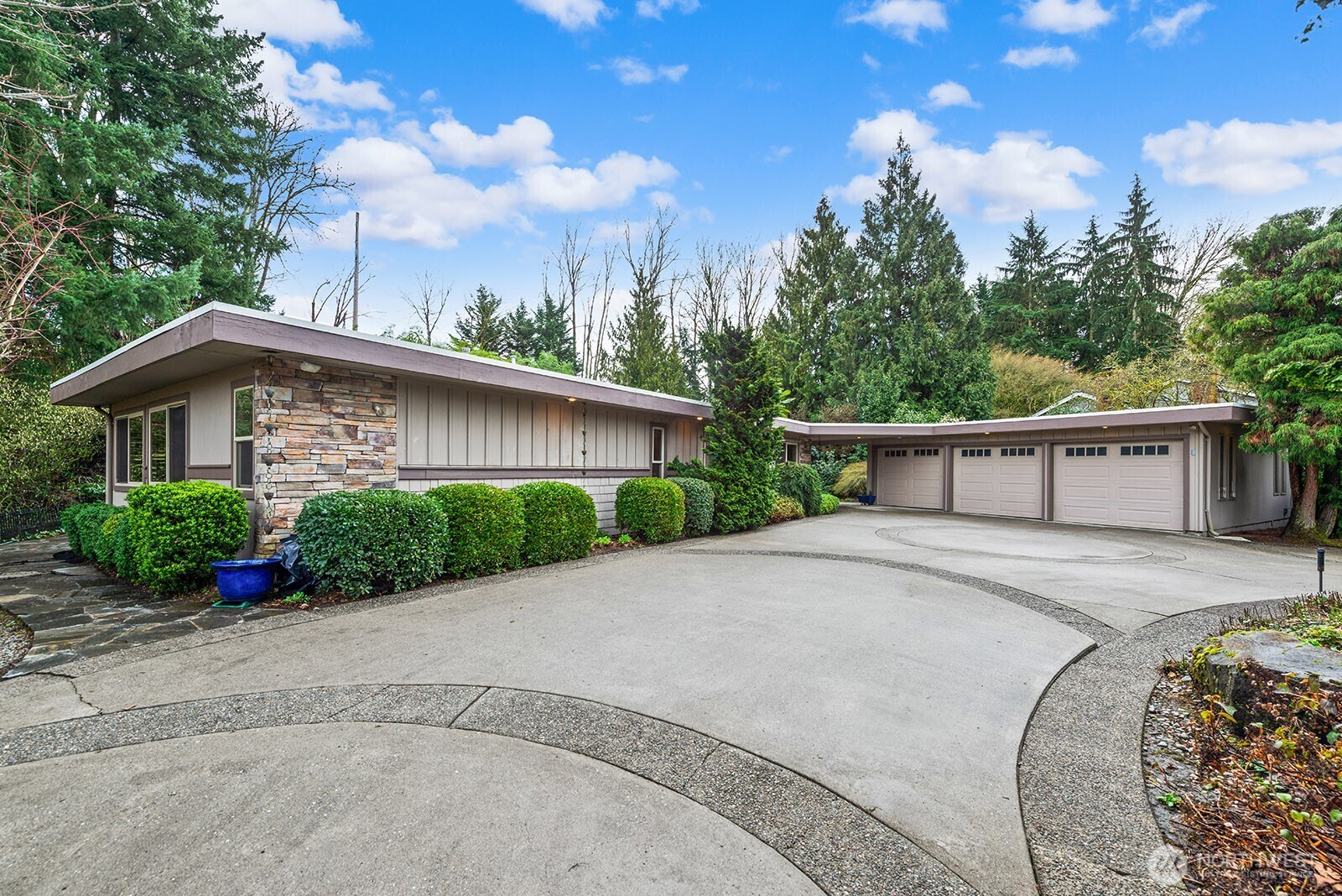 An oversized semi-circular driveway provides easy and ample parking for guests.