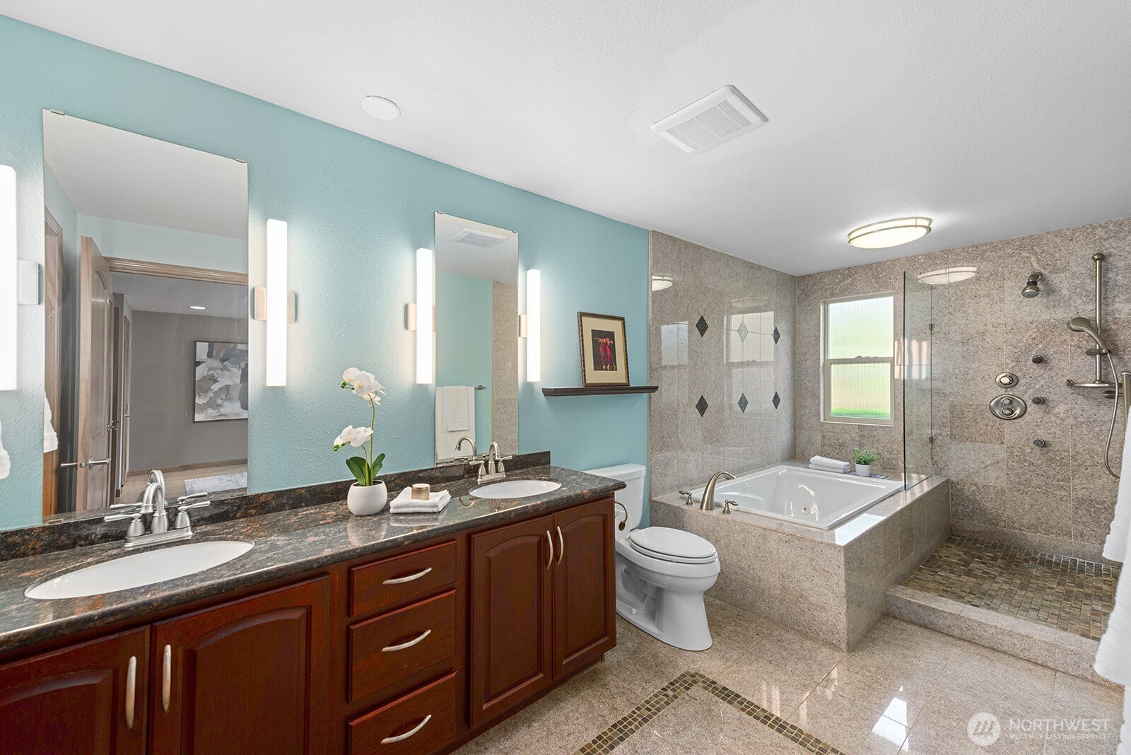 The primary bathroom features a double vanity, large walk-in closet, jetted tub, and shower.