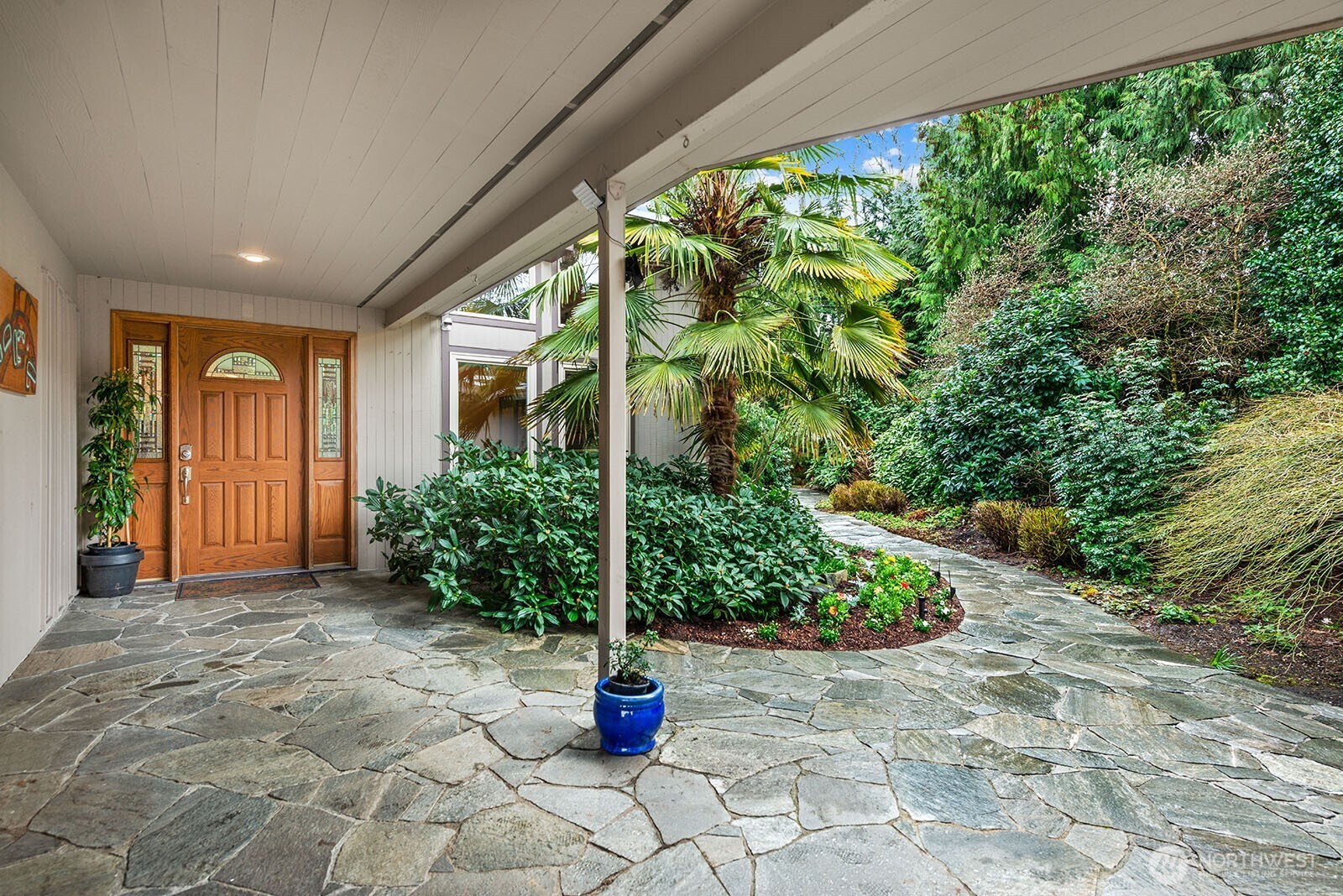 Large welcoming covered walkway from the garage to the house.