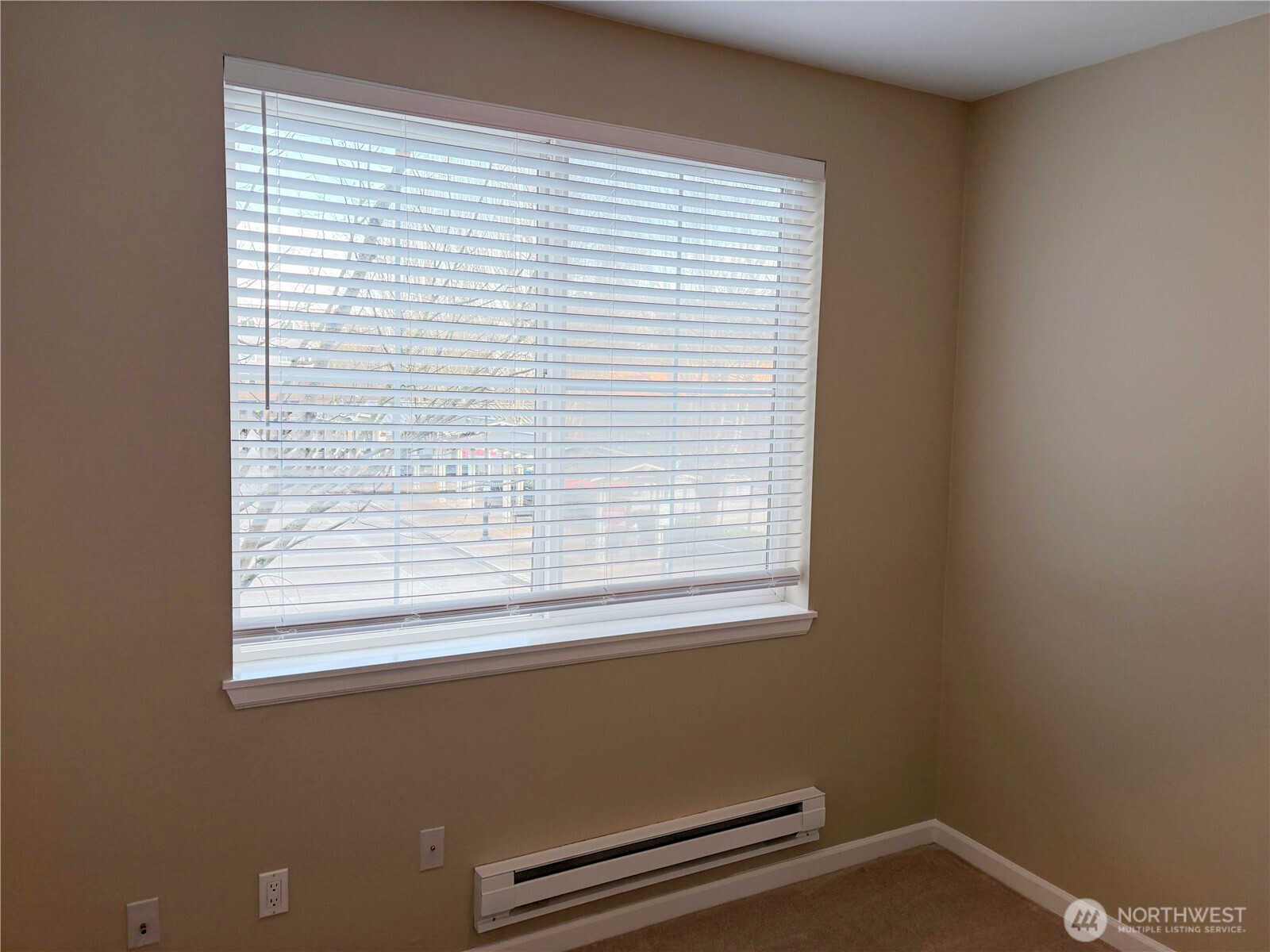 Bedroom window providing natural light and a quiet retreat within the city.