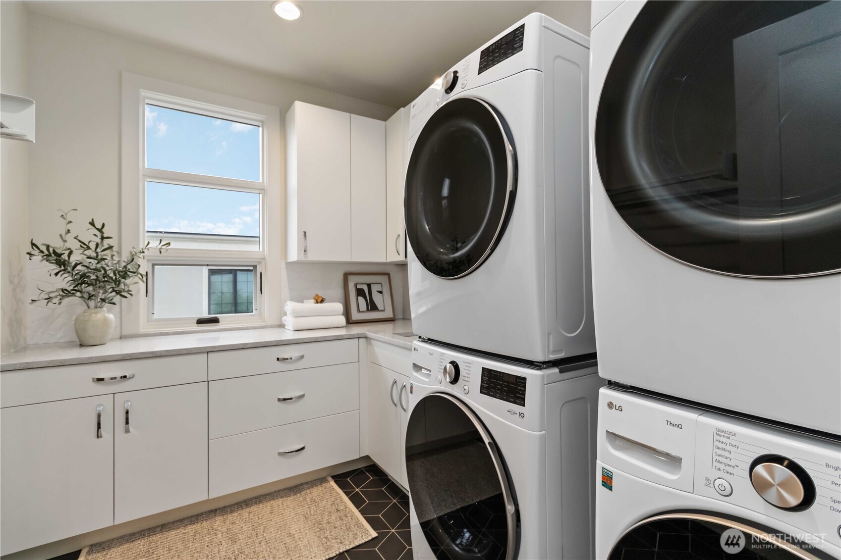 Secondary laundry room with dual units upstairs.