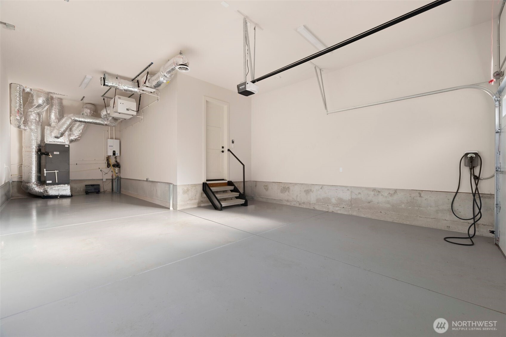 3-car tandem garage with Navien tankless water heater and wired for 2 EV chargers.