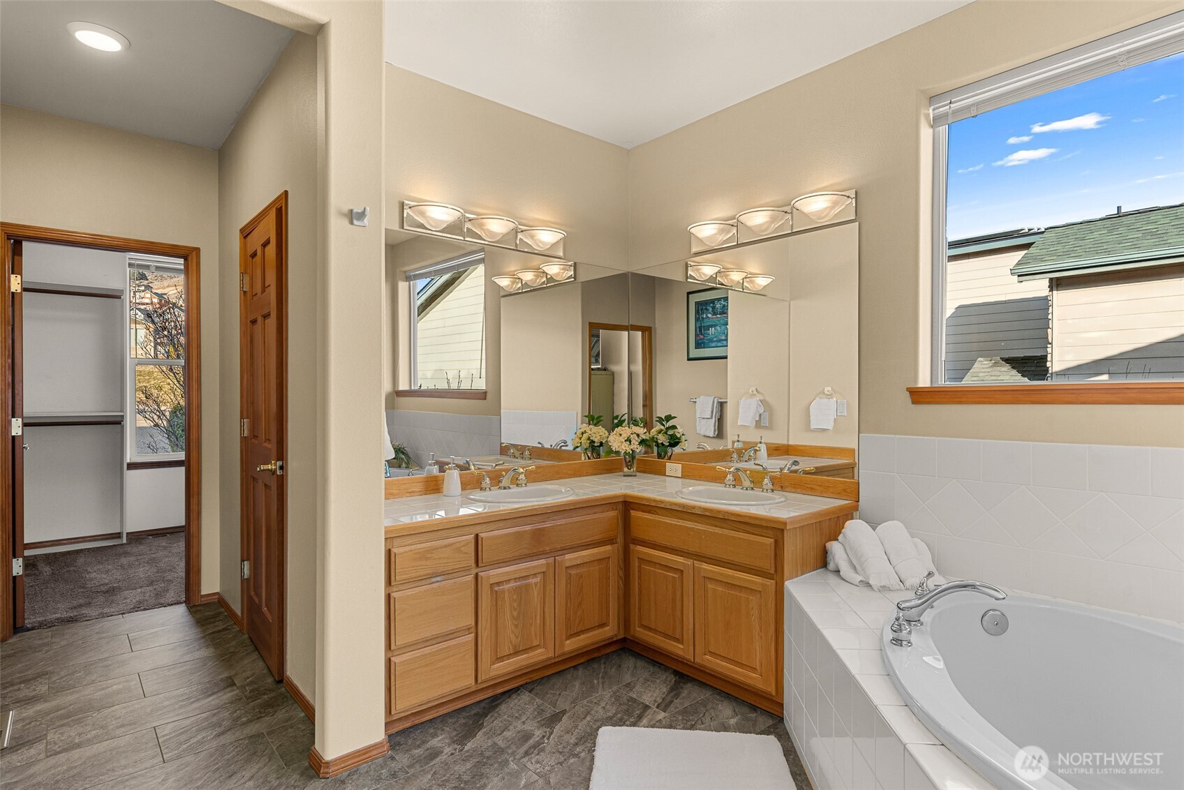 Ensuite bathroom with soaking tub and large walk in closet