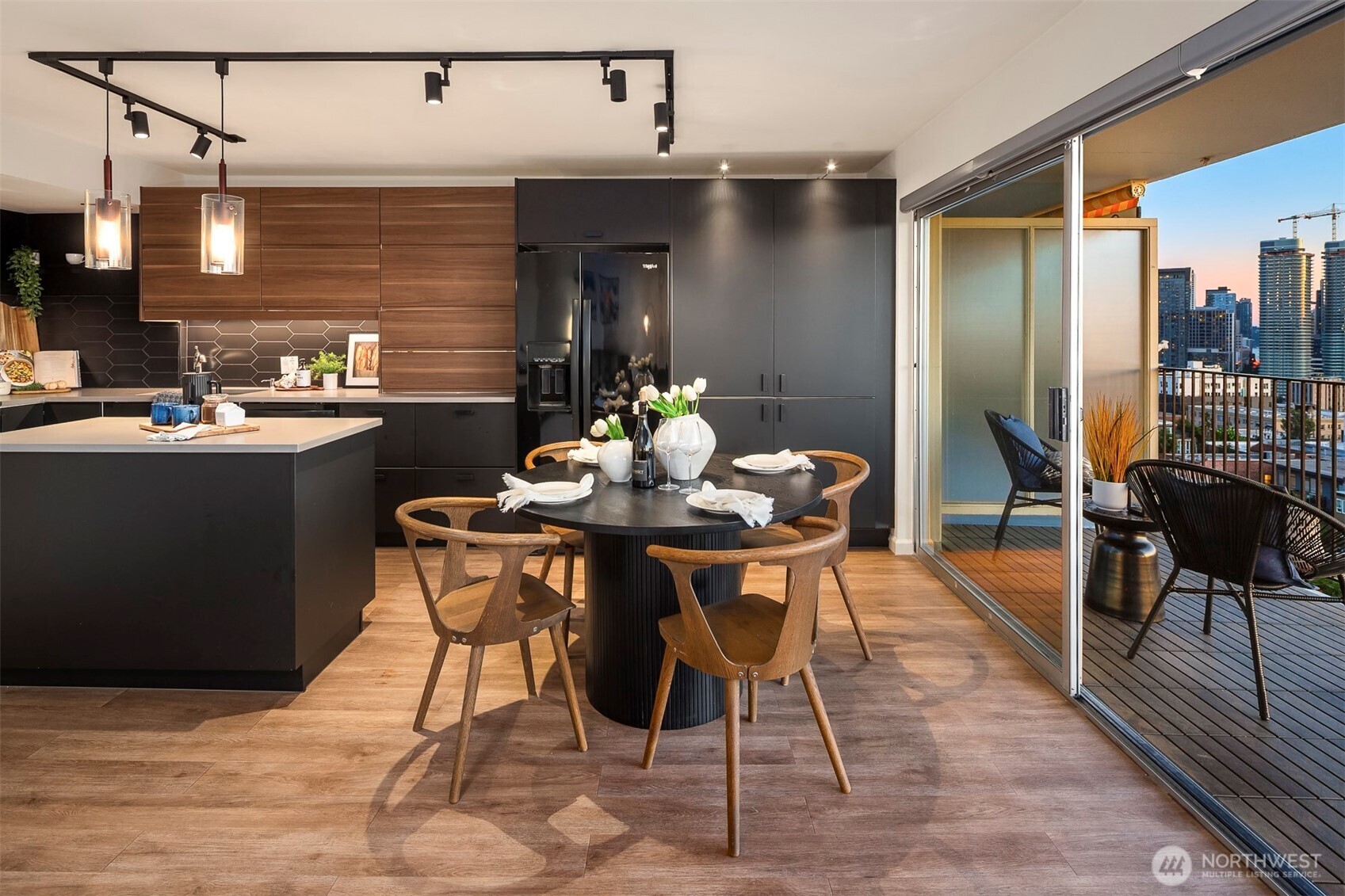 The beautifully updated kitchen flows seamlessly into the view-facing dining and living areas.