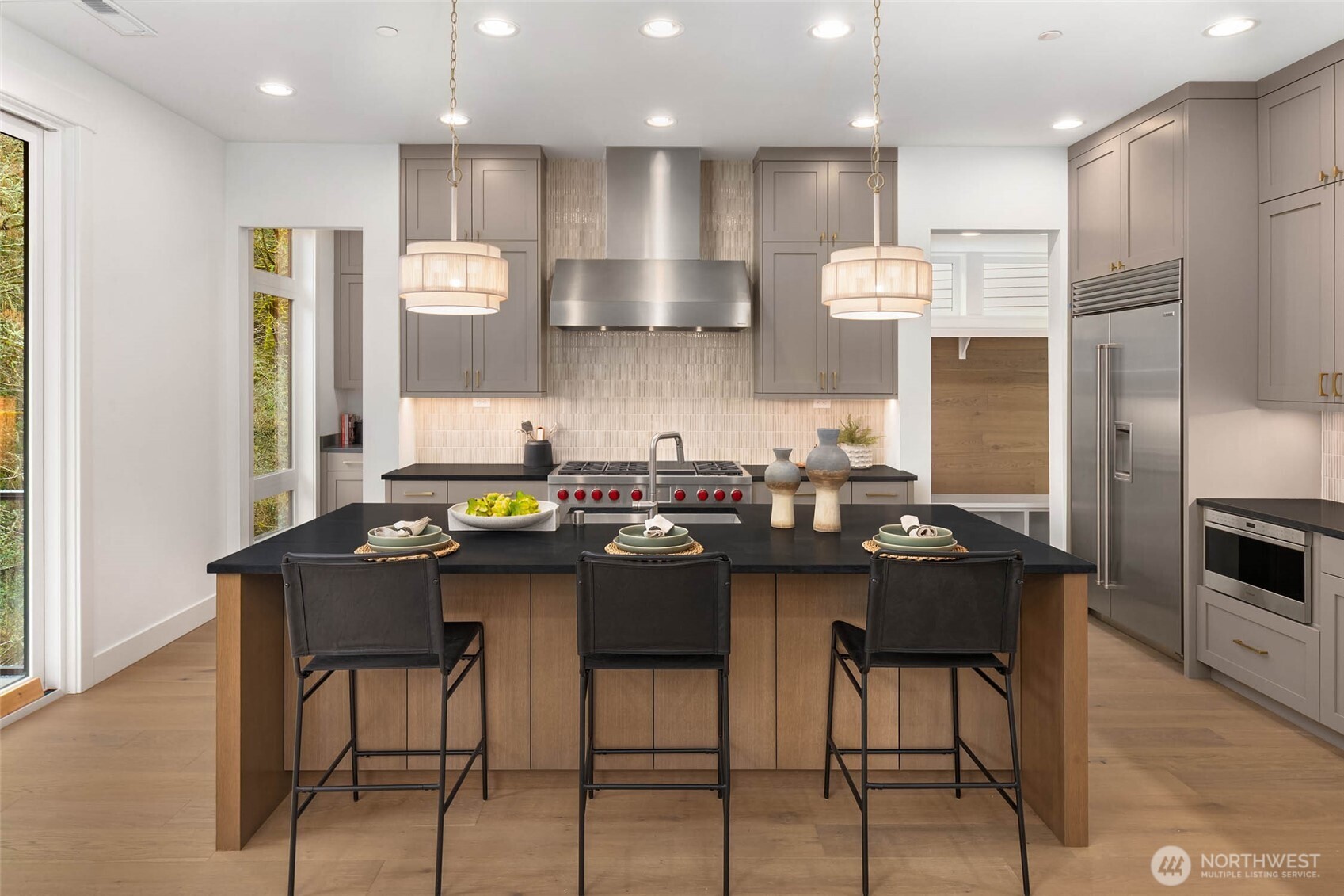 Chefs kitchen features 48" duel fuel Wolf Range with 6 burners, infrared griddle, and double oven, built in 42" Sub zero refrigerator, subzero undercounter beverage fridge, in counter Wolf Microwave drawer, and sleek and quiet stainless steel cove dishwasher