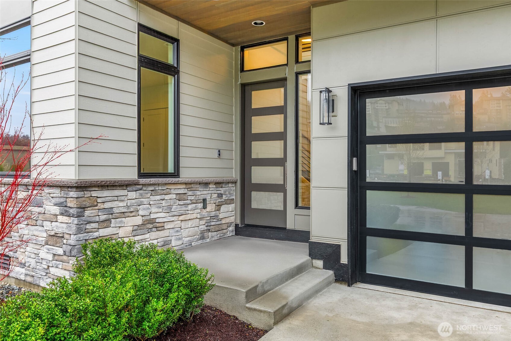 Covered entry with stained cedar ceiling and stone details welcome you