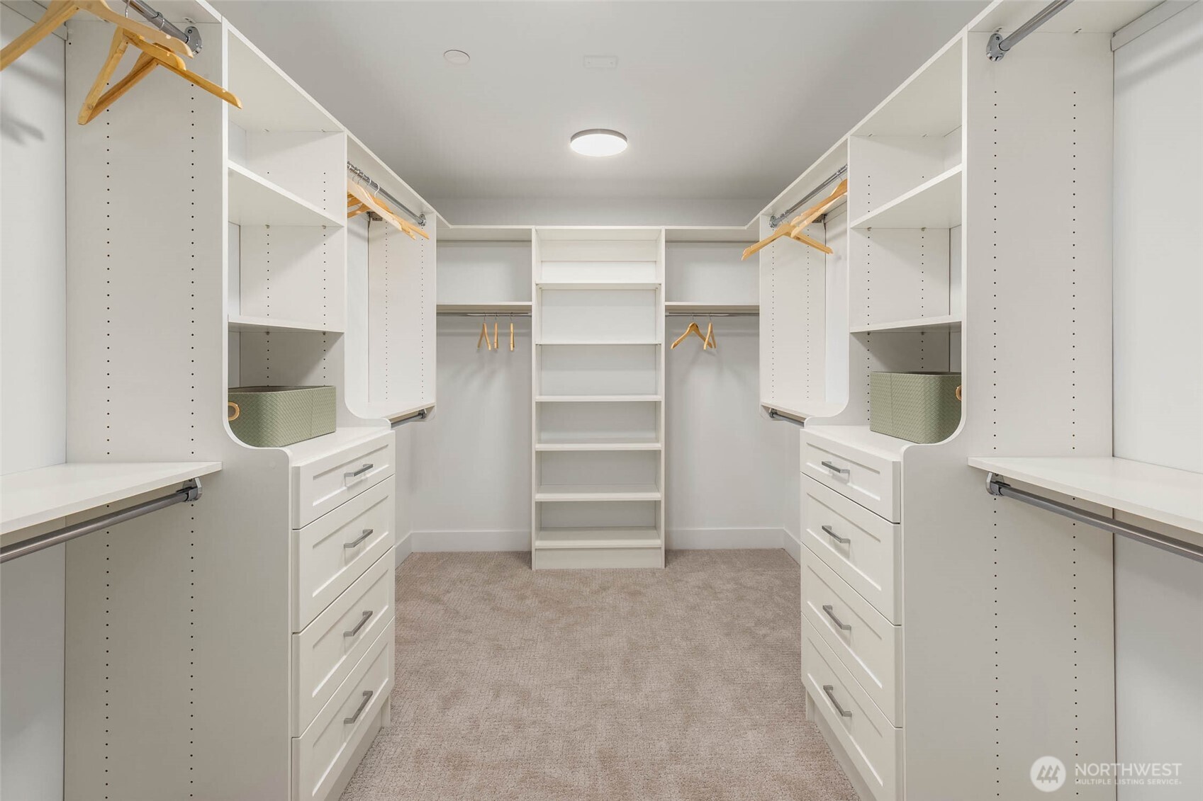 Spacious primary closet with custom designed and built solid shelving and drawers. Solid closet shelving throughout the home