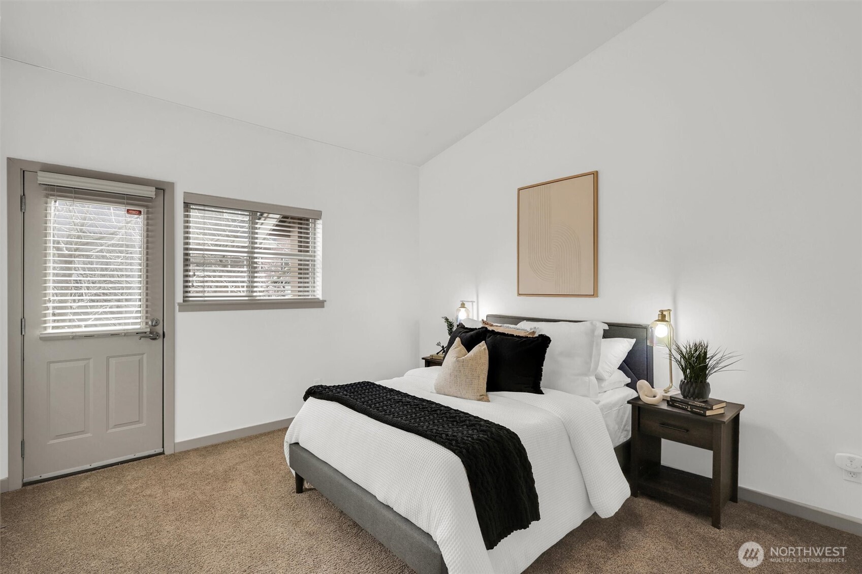 Comfortable master bedroom on main level with neutral tones and ample space.