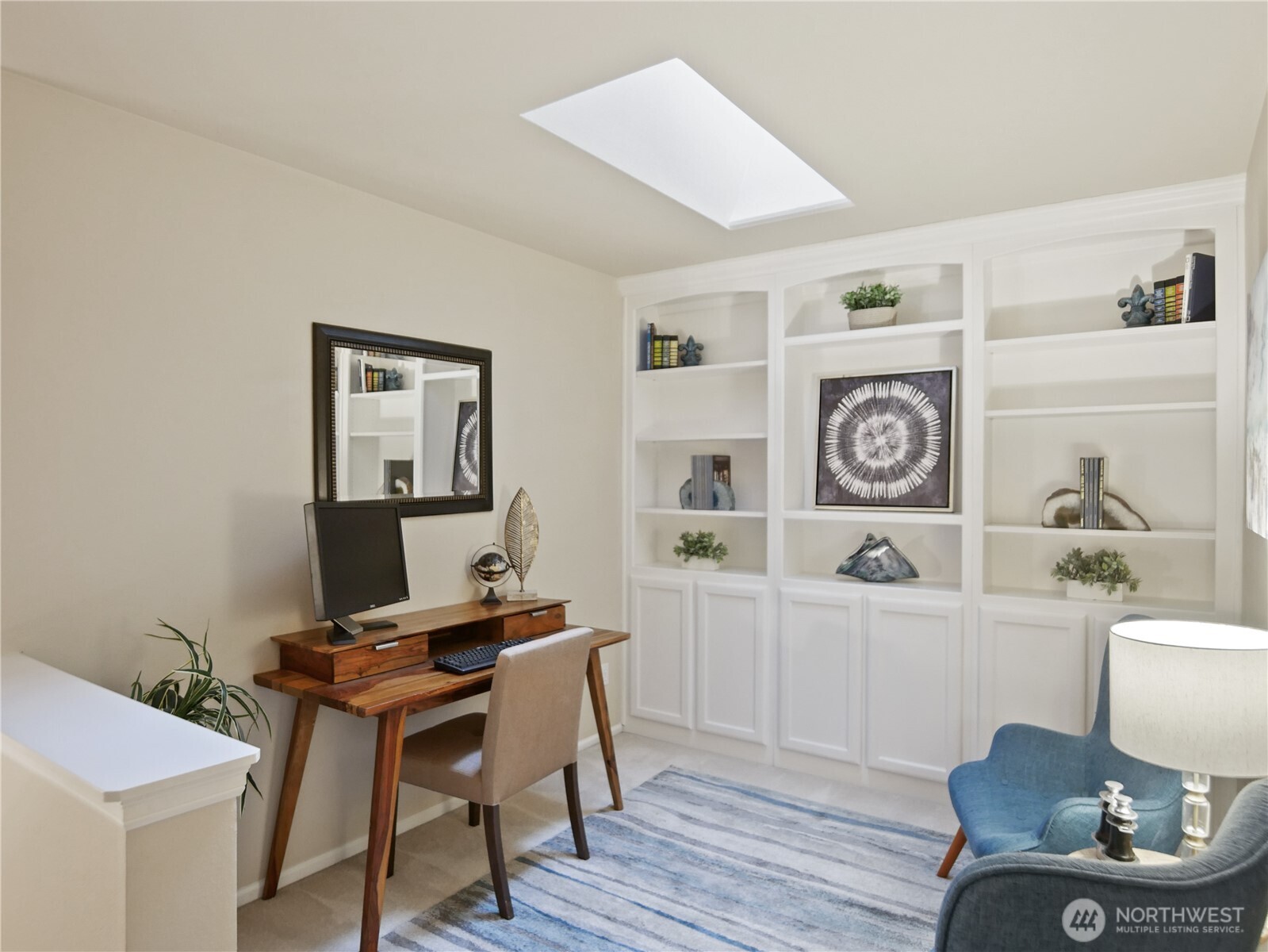 This versatile loft features built in shelving, a skylight and is an ideal home office or den.
