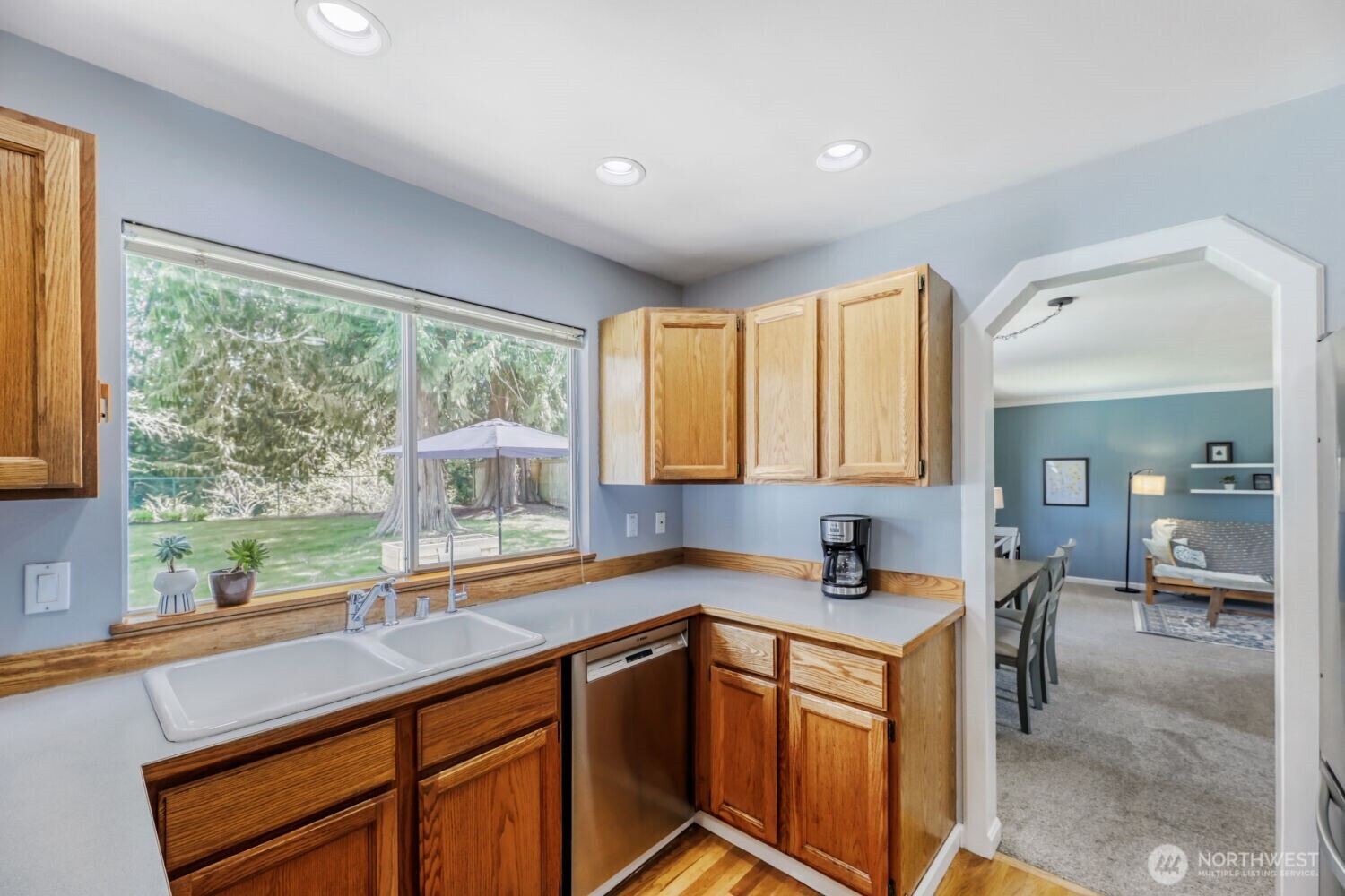 Kitchen looking out to private fenced backyard