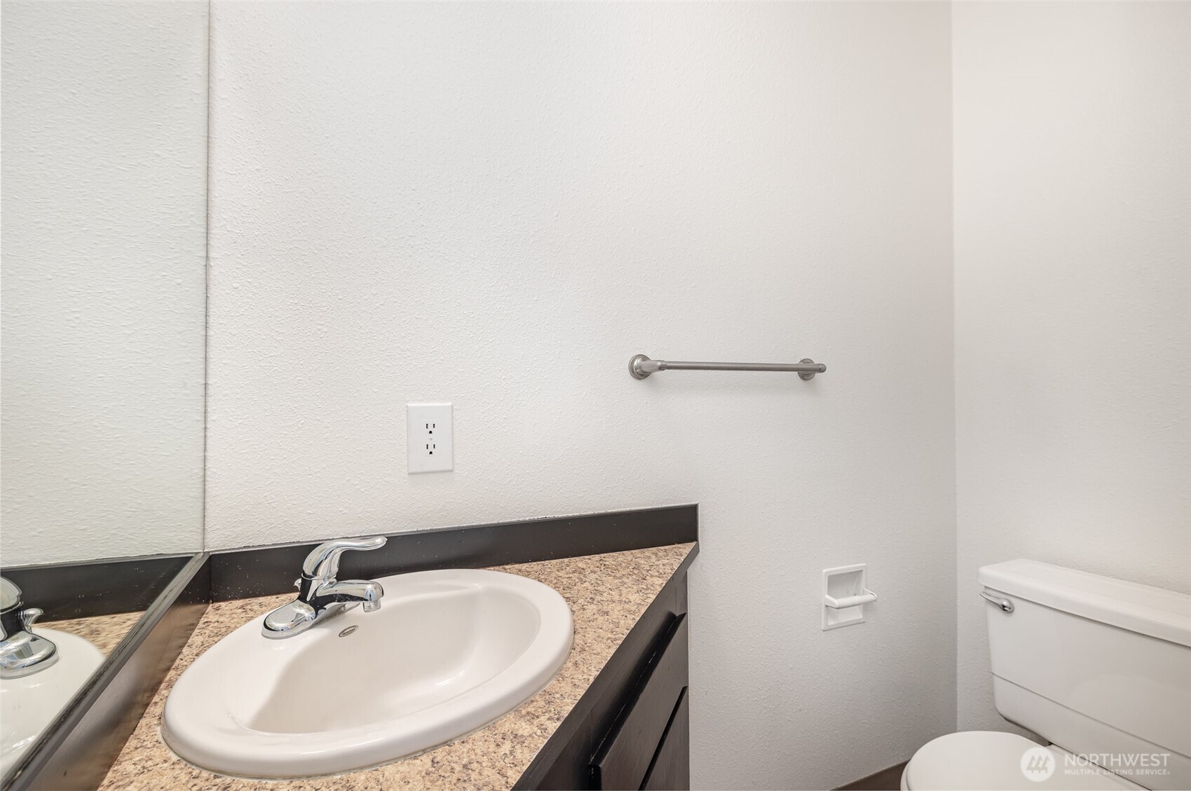 Hallway half bath for guests.