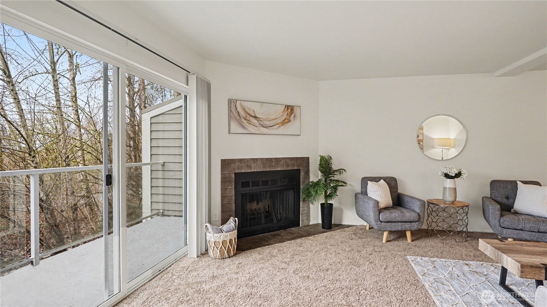 Cozy fireplace in the living room with lots of natural light from your private balcony.