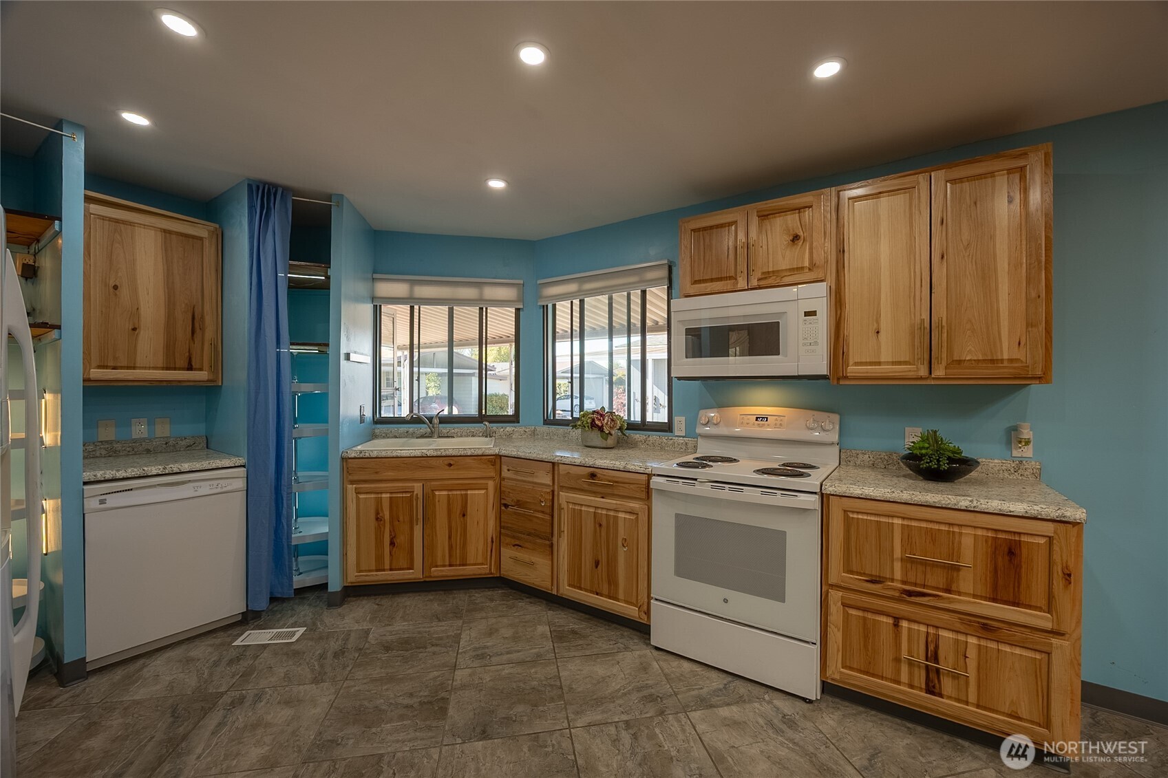 Bright Kitchen with recessed lighting. Stove, Microwave, Dishwasher, Refrigerator, 2 lighted Pantries with Turntable Shelves, Garbage Disposal and Deep large Cupboards and Drawers.
