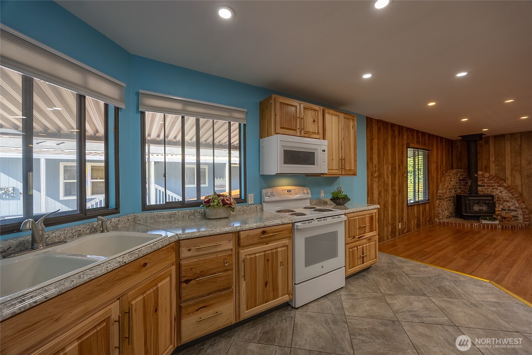 View from Kitchen towards Family Room with recessed lighting and Wood Stove